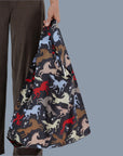 A black nylon tote bag with multi colored horse patterns. 