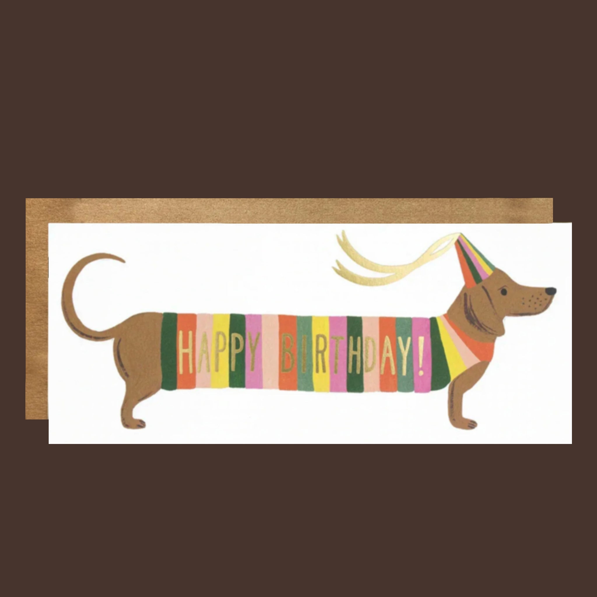 A long birthday card with a graphic of a wiener dog wearing a striped multi colored sweater and birthday hat that reads, 'Happy Birthday!'. 