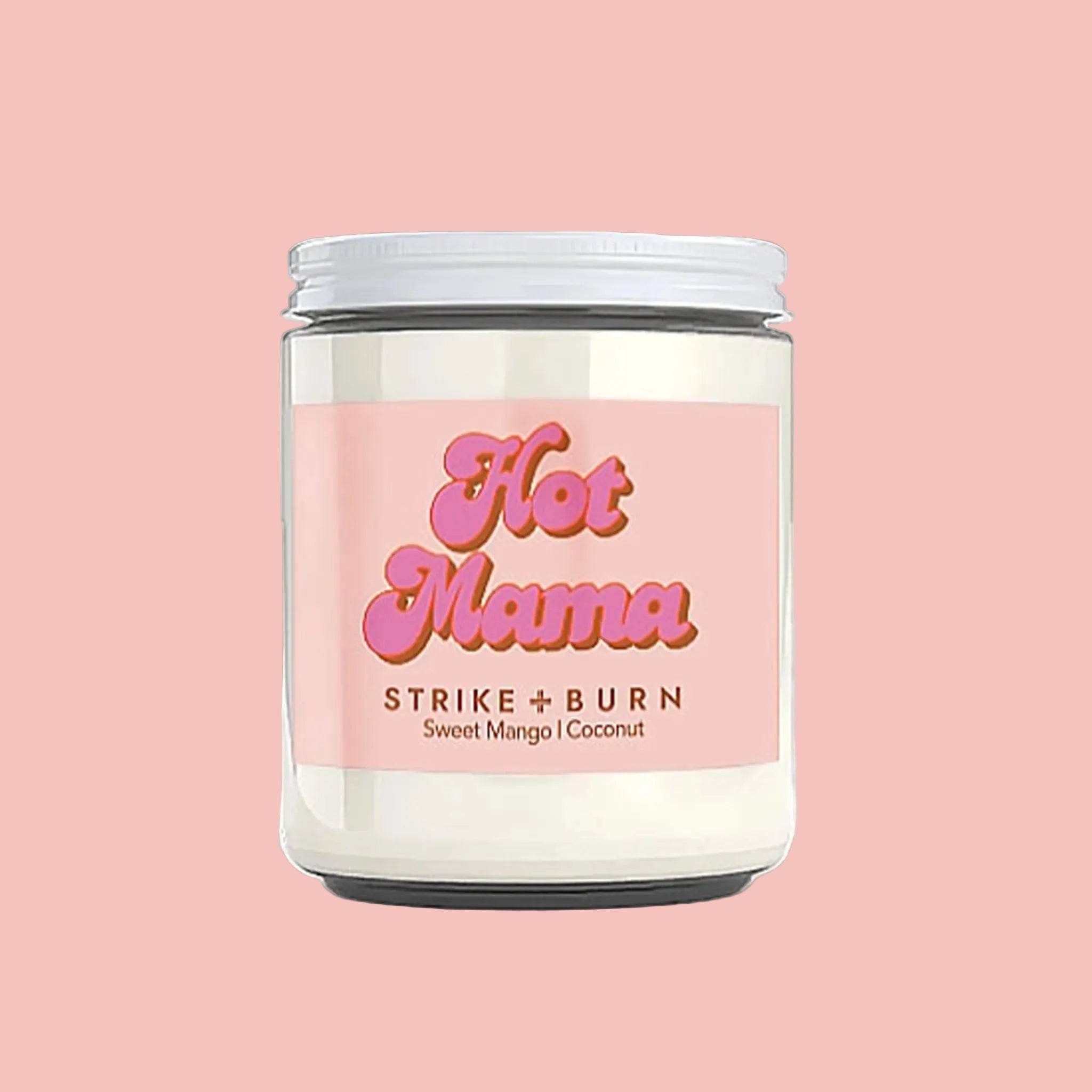 A candle with a pink label that reads, "Hot Mama Strike + Burn Sweet Mango | Coconut". 