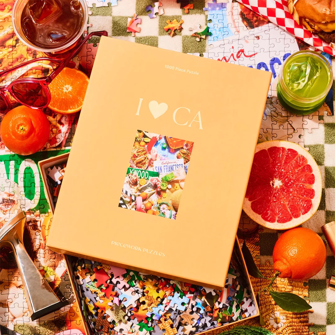 A puzzle box with the title, &quot;I &lt;3 CA&quot; that has images of the iconic state of California including, green juices, sunglasses, animal style burgers and fries, tacos, a Hollywood street sign and more.