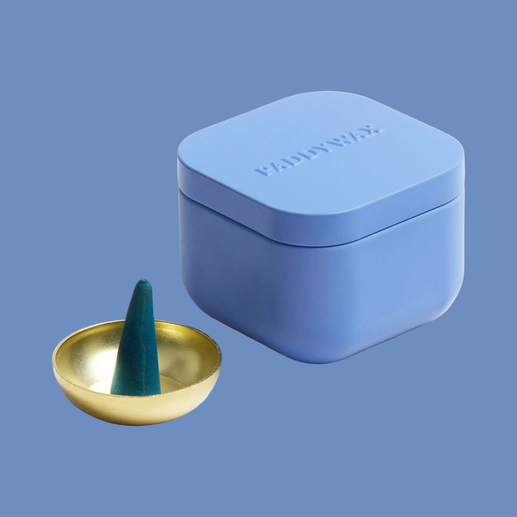 A blue tin of teal incense cones. 