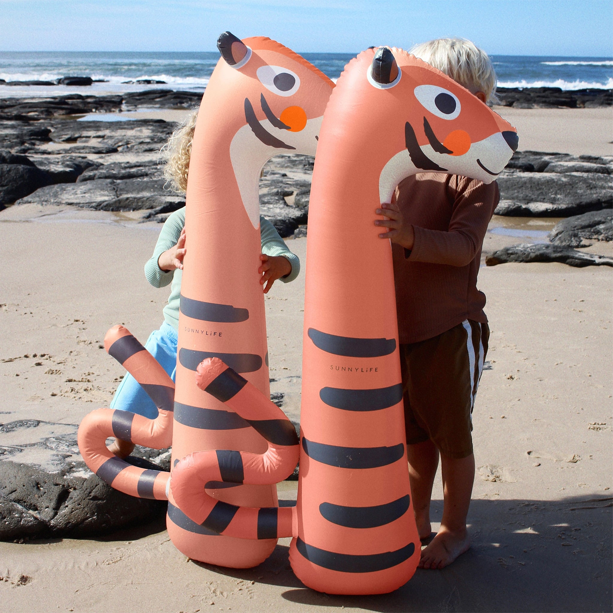 A set of two orange tiger pool floats. 