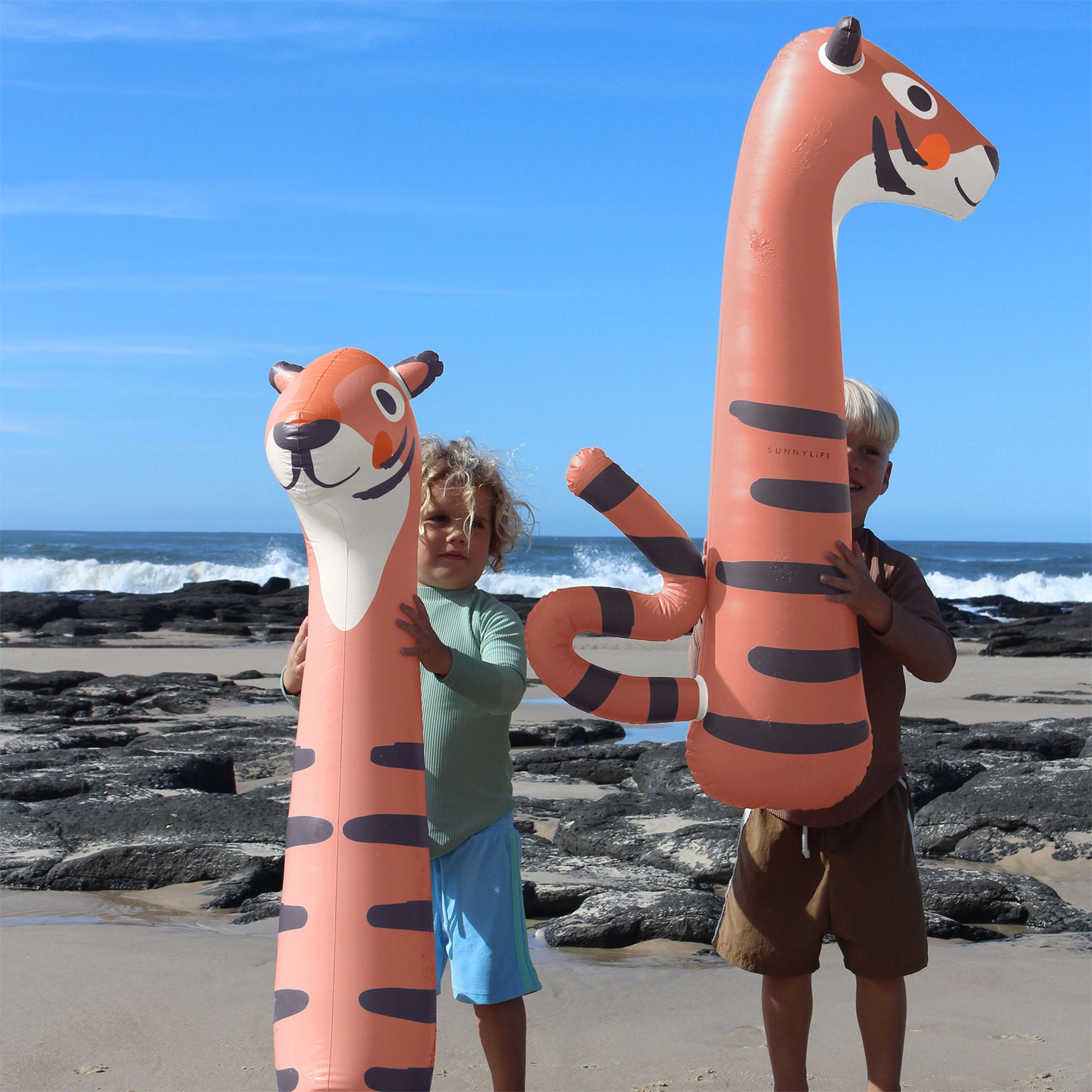 A set of two orange tiger pool floats. 