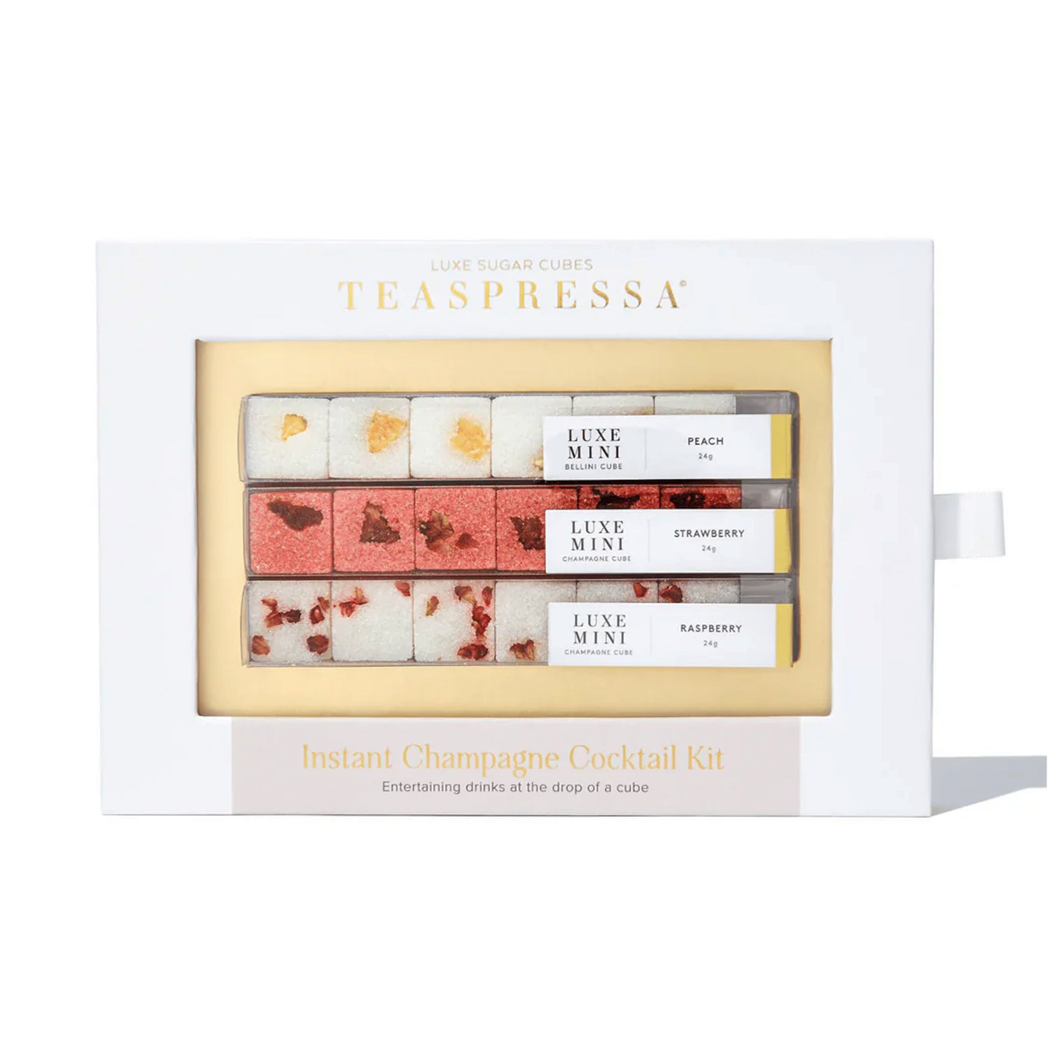 On a cream background is a sugar cube cocktail kit that reads, "Teaspressa Instant Champagne Cocktail Kit" with a set of three sugar cube strips that come in three flavors.