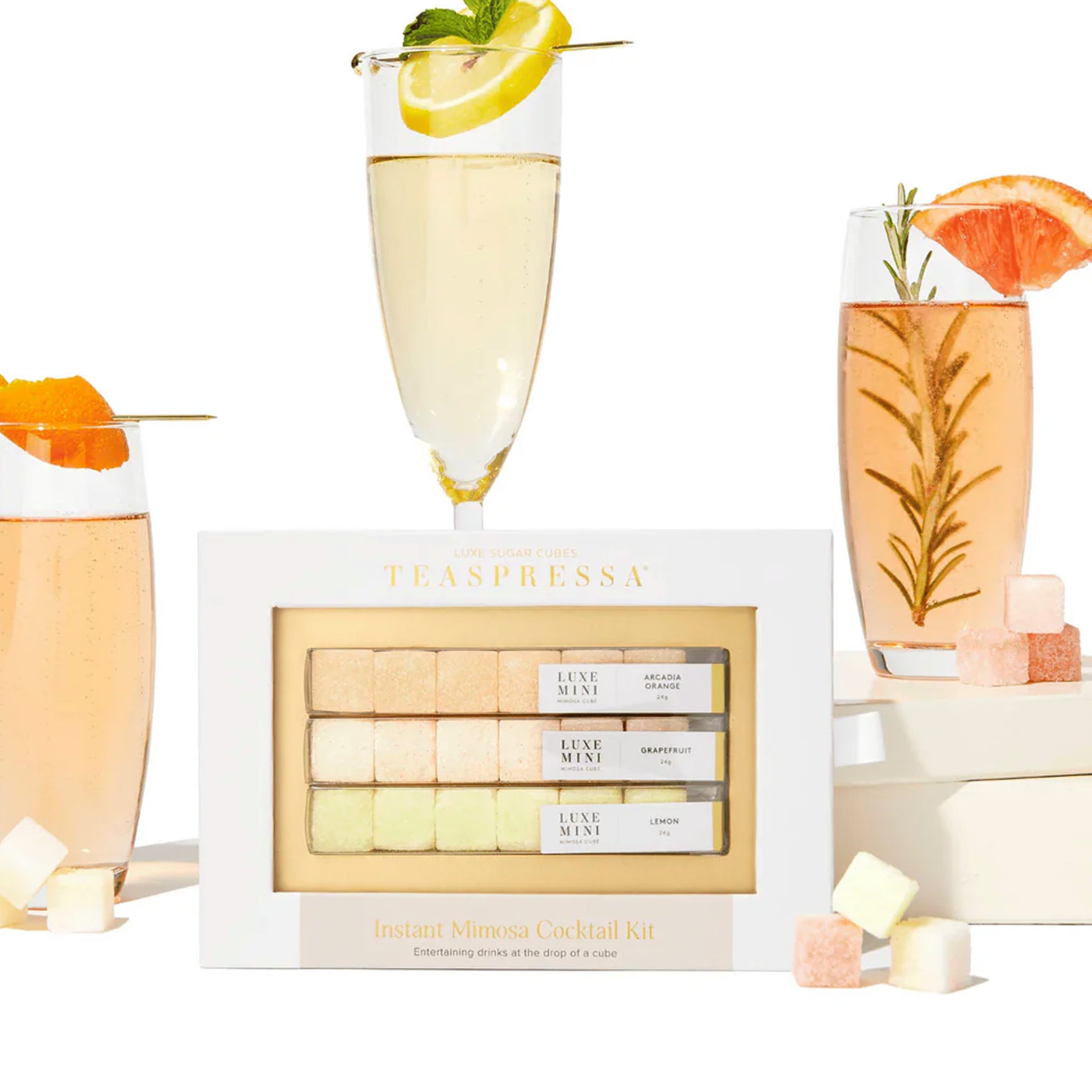 On a cream background is a set of three different flavored sugar cubes made for instant mimosa cocktails. The packaging reads, &quot;Teaspressa Instant Mimosa Cocktail Kit&quot;.