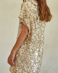 A gold sequin mini dress with short sleeves and a v-neck. 