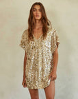 A gold sequin mini dress with short sleeves and a v-neck. 