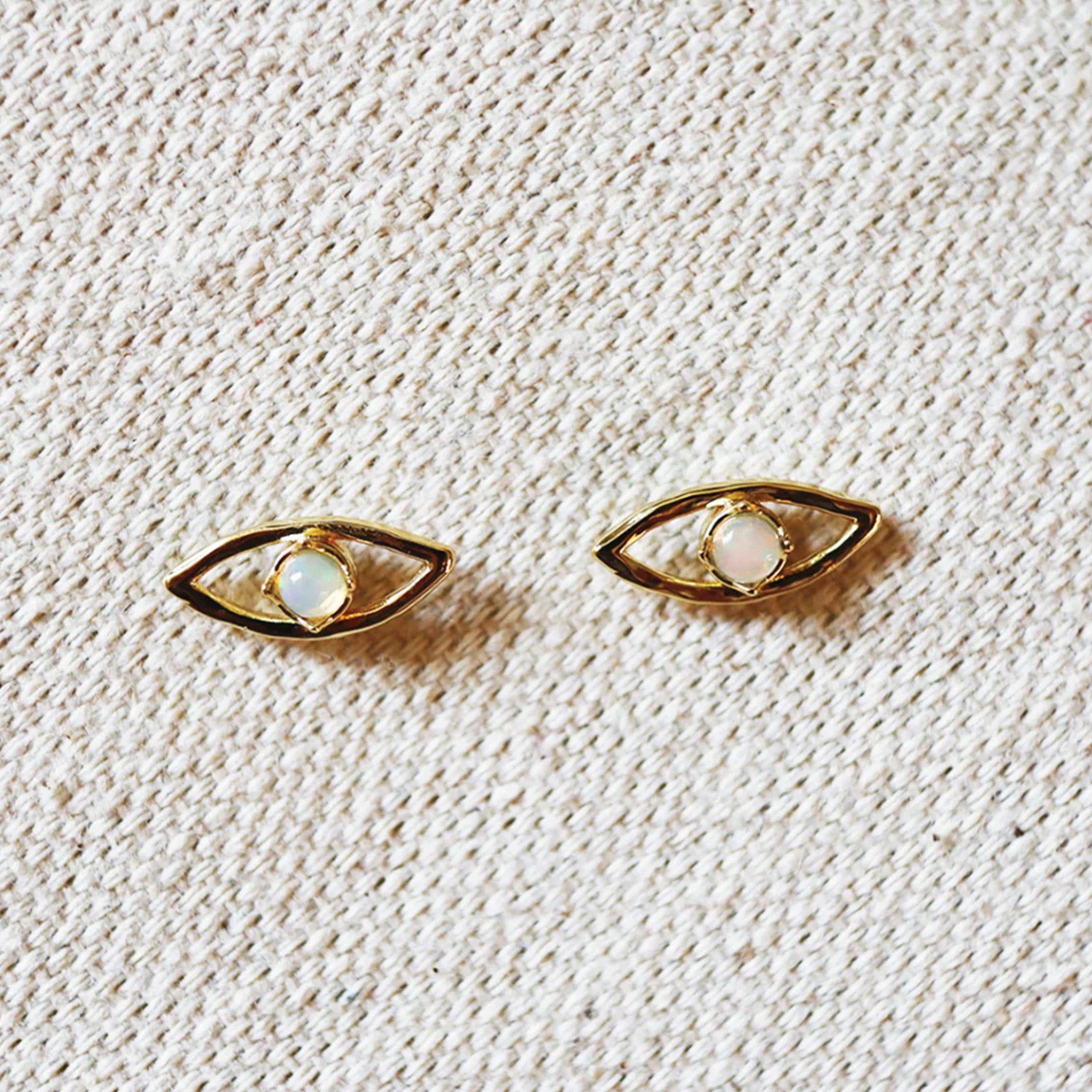 A pair of eye shaped stud earrings. 