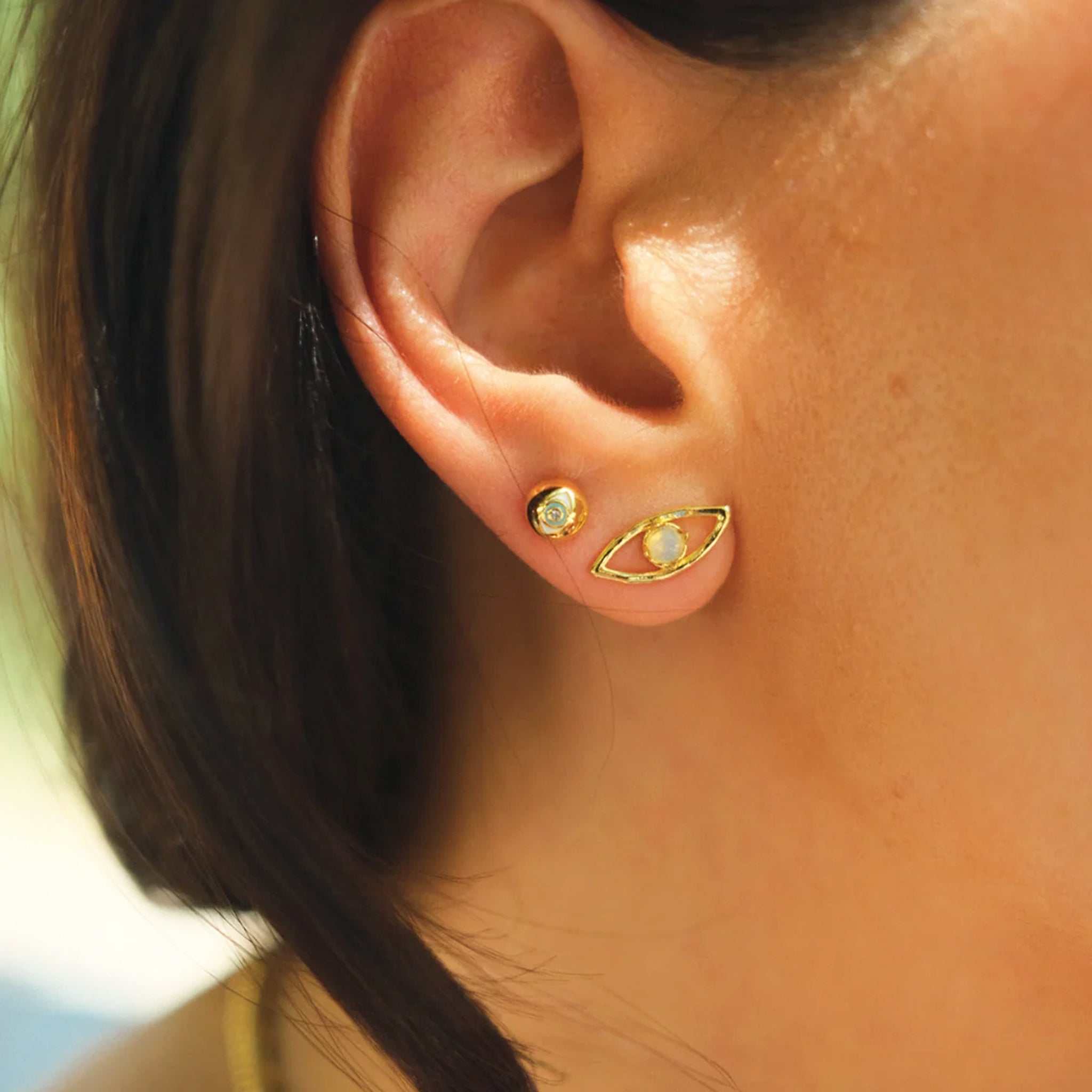 A pair of eye shaped stud earrings. 