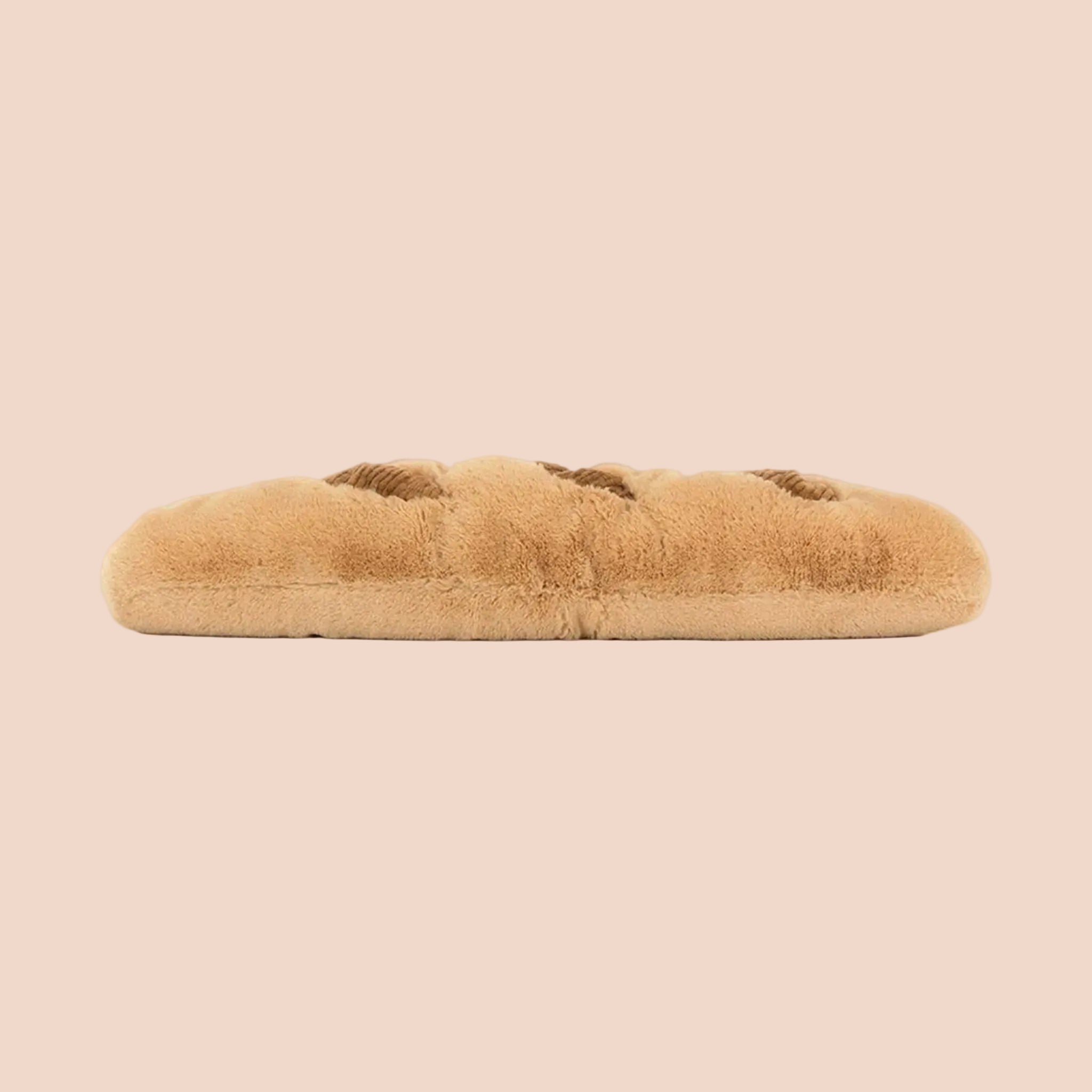 A baguette shaped stuffed toy with an adorable smiling face and brown corduroy feet. 