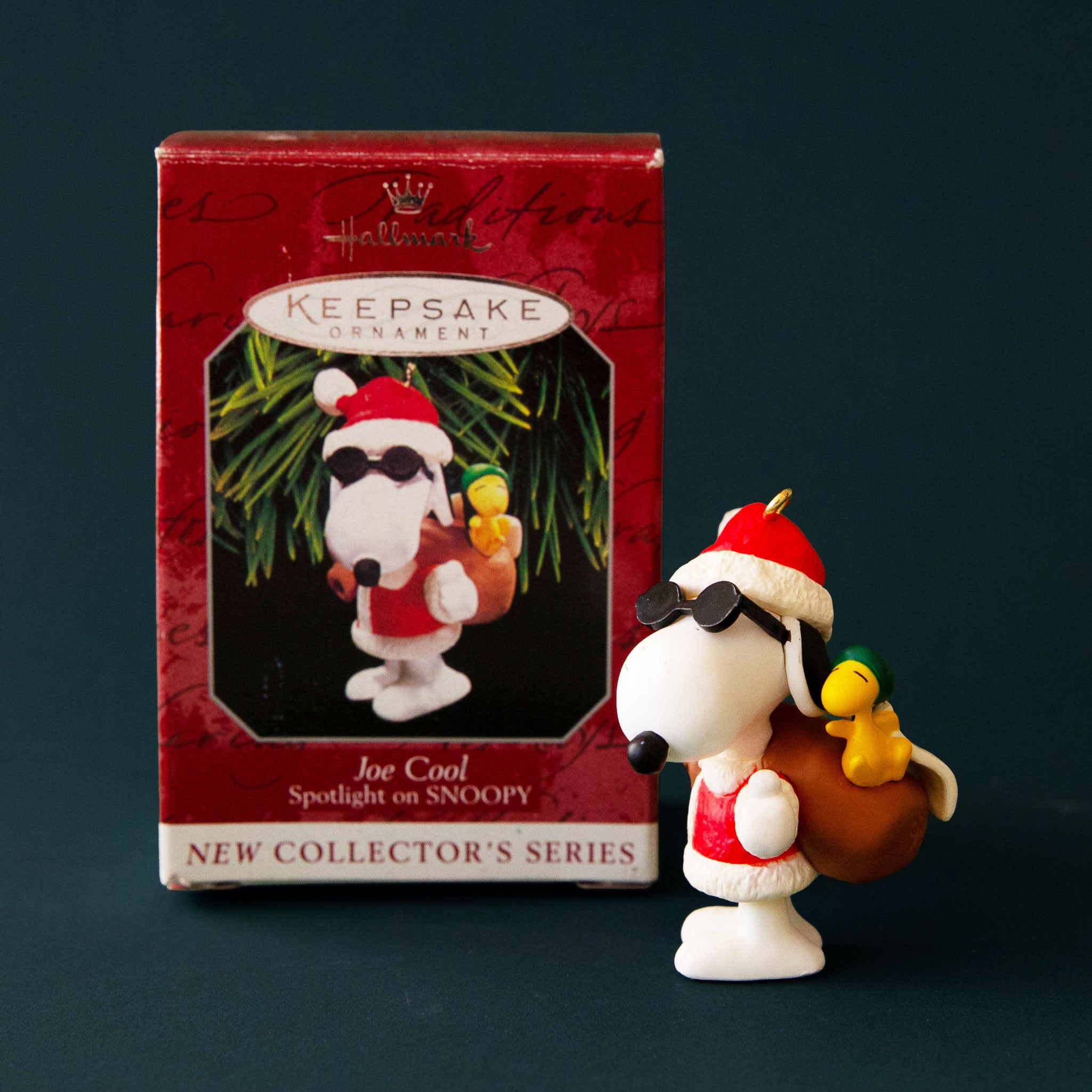 A vintage ornament in the shape of Snoopy in a Santa and sunglasses outfit. 