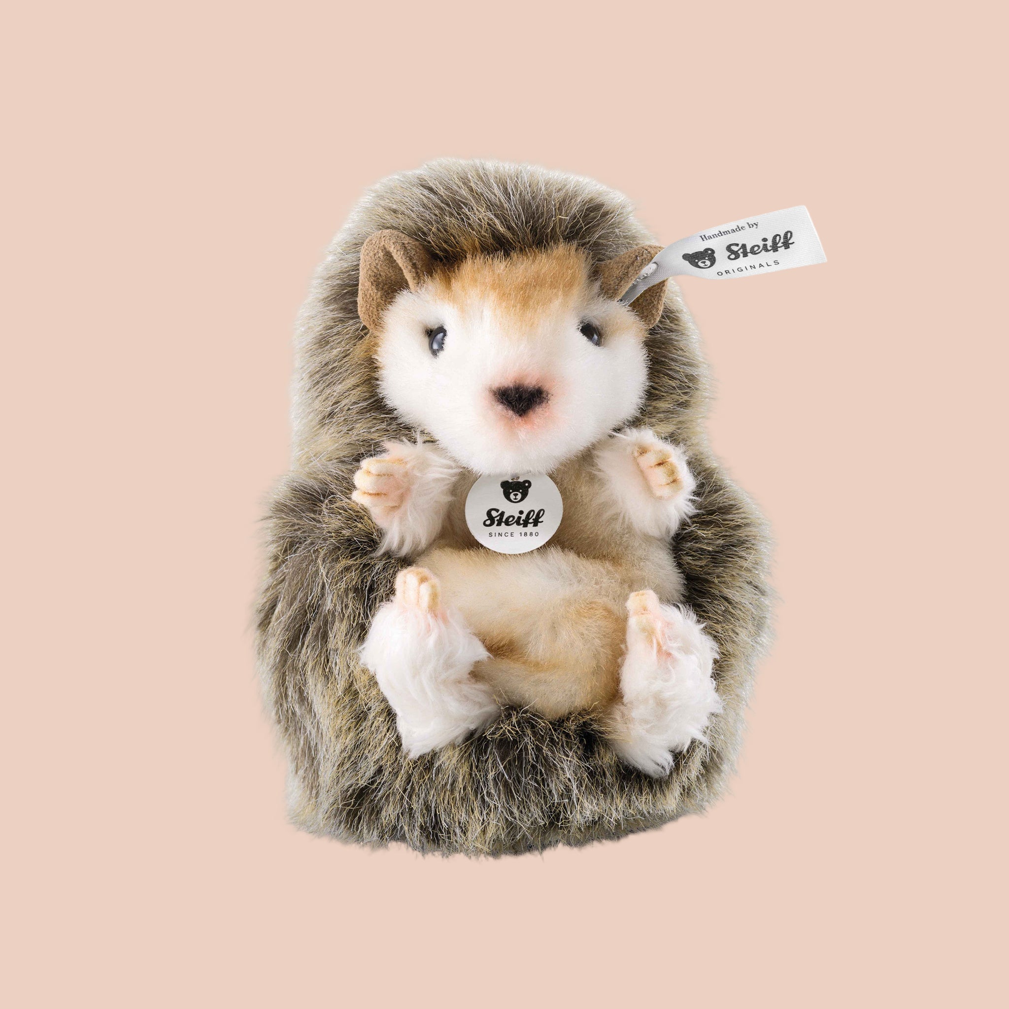 A brown and tan hedgehog shaped stuffed toy. 