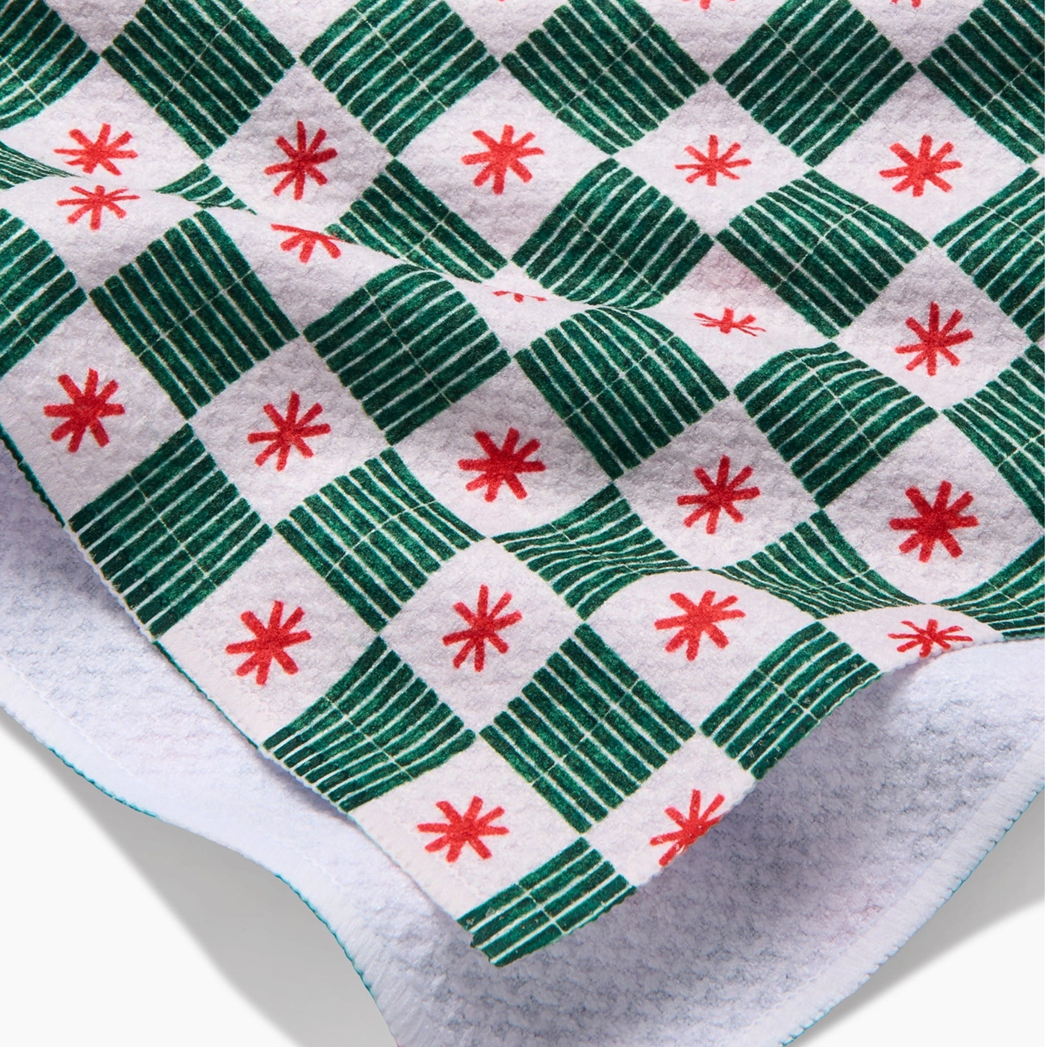 A green, red and white grid pattern kitchen towel with a waffle texture. 