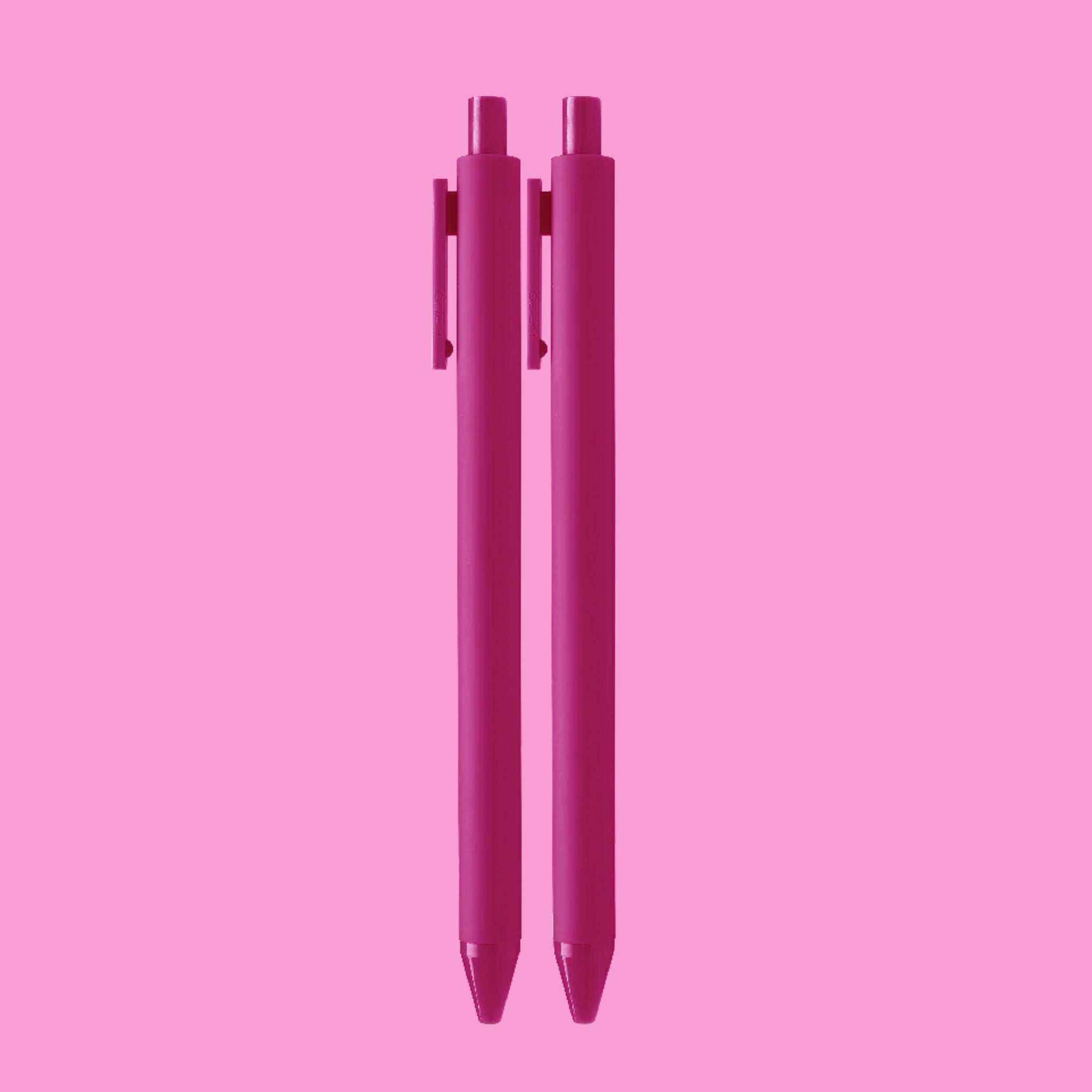 On a pink background is a light pink set of ballpoint pens.