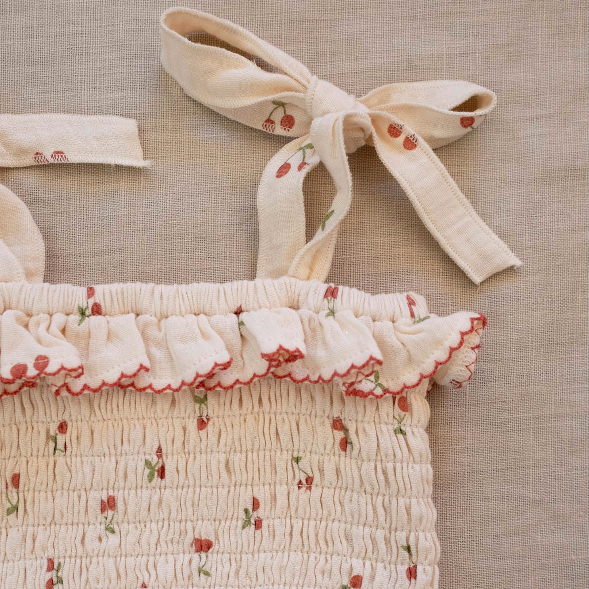 An ivory tank and bloomer set with a cherry print.