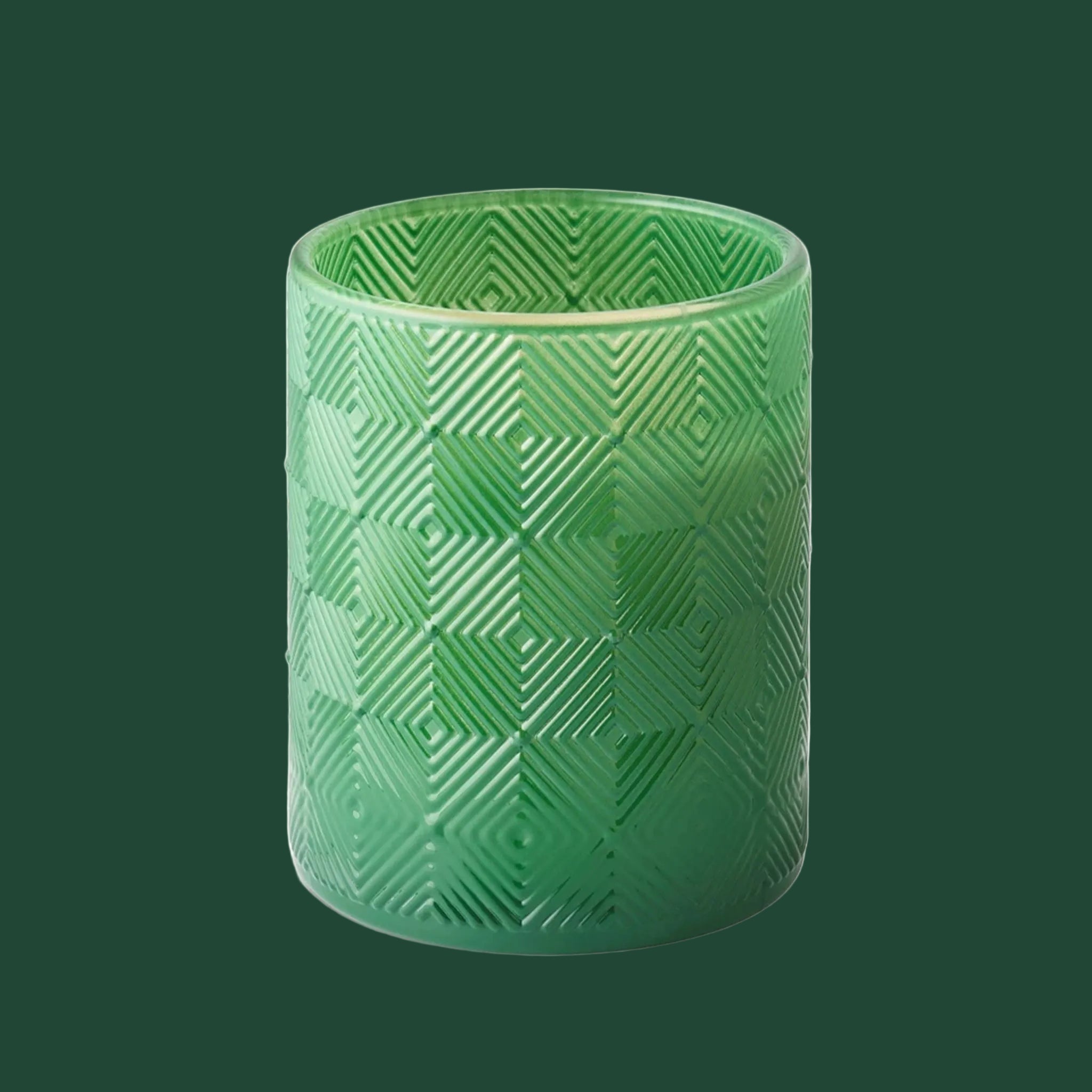 A green textured glass jar candle.