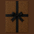 Leopard print wrapping paper wrapped present on a brown background with a black ribbon bow.