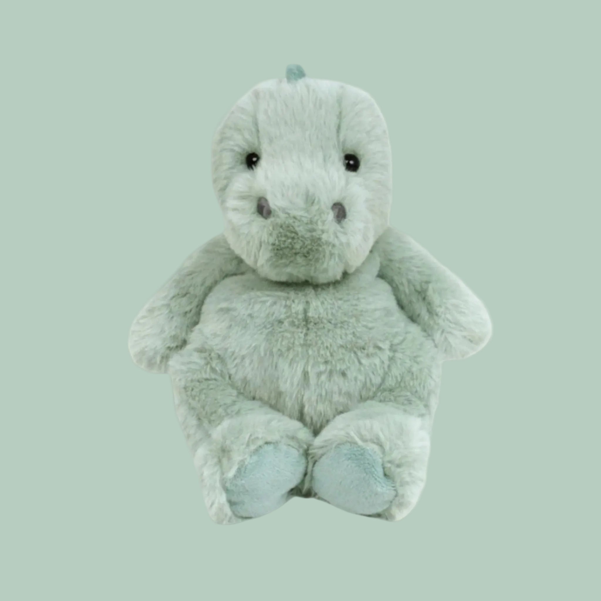 A green dinosaur shaped stuffed animal.