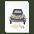 card with a black getaway card decorated with a banner that reads, "Just Married" and greenery around it as well as gold foiled cans coming from the bottom of the car. 