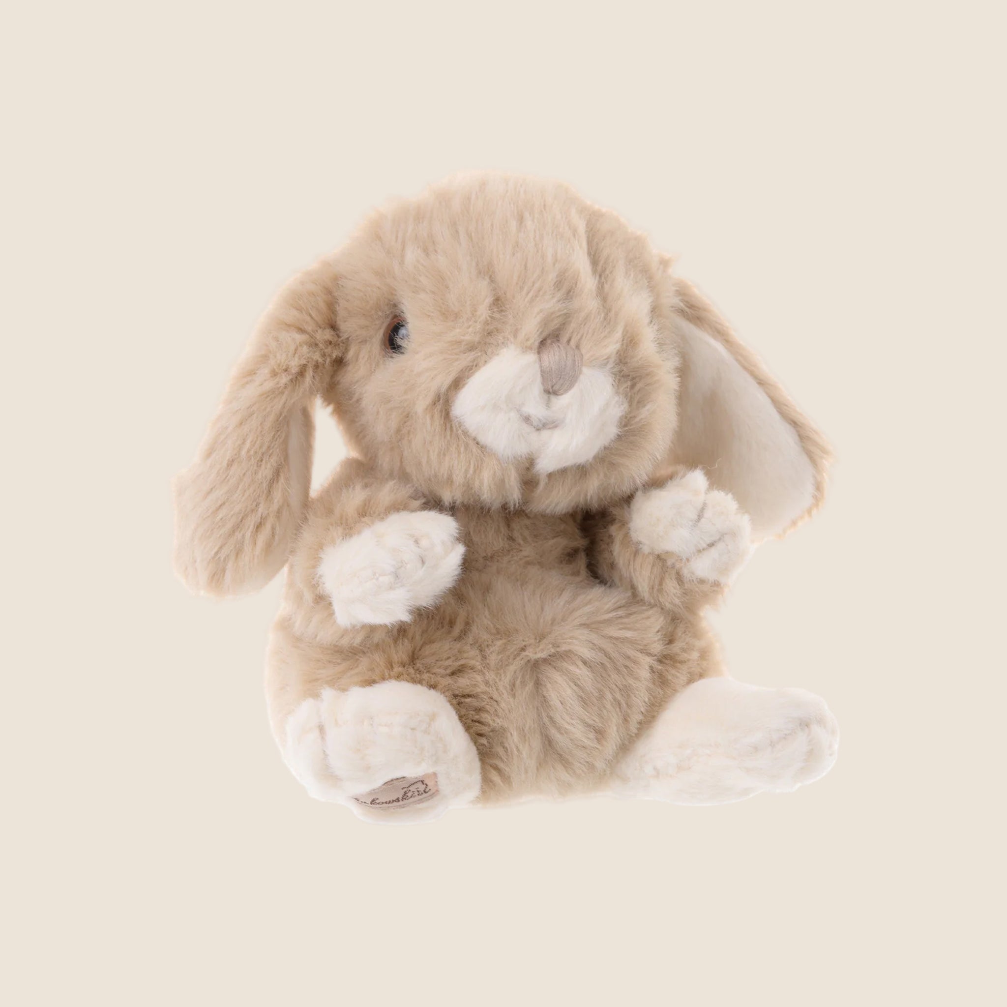 A tan fluffy bunny shaped stuffed animal toy. 