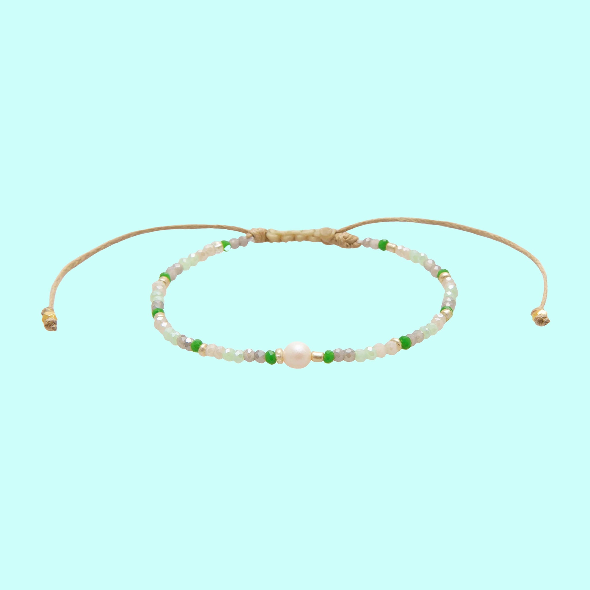 A beaded turquoise, white and green bracelet with an adjustable string. 