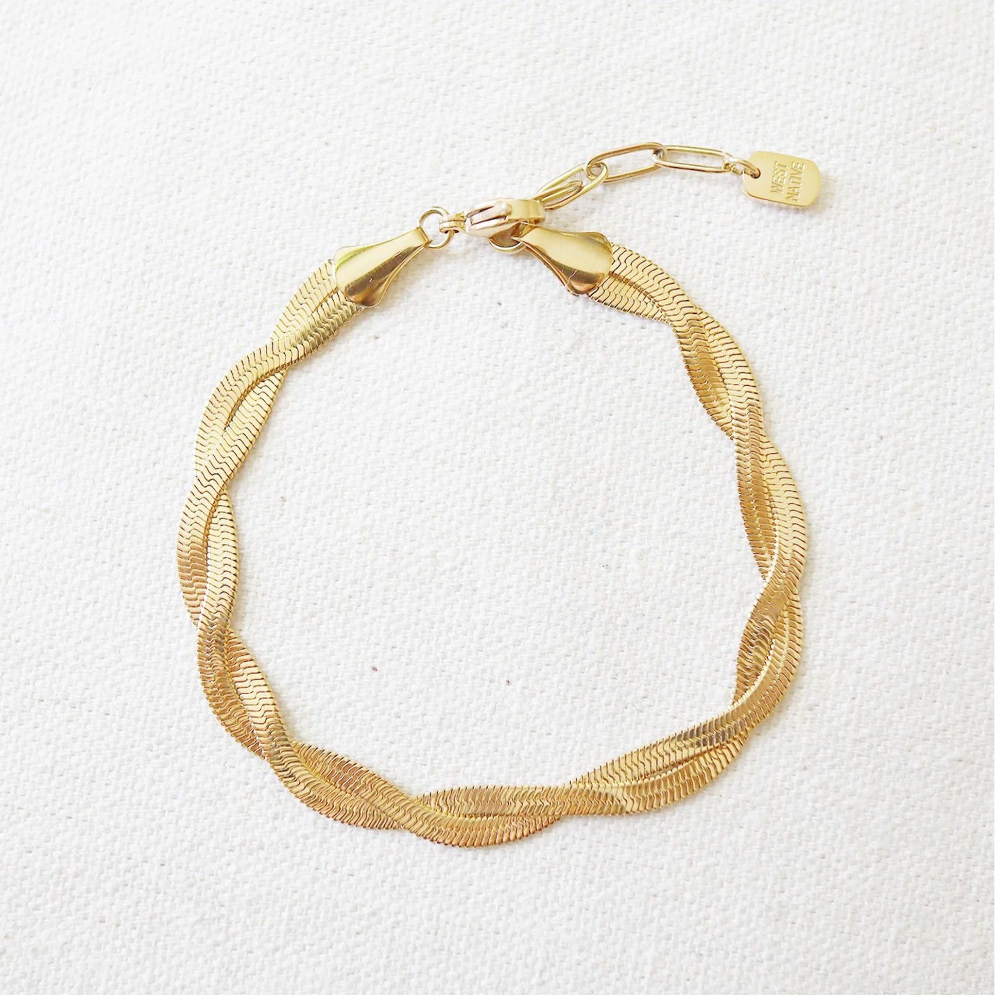 A gold snake chain twisted bracelet. 