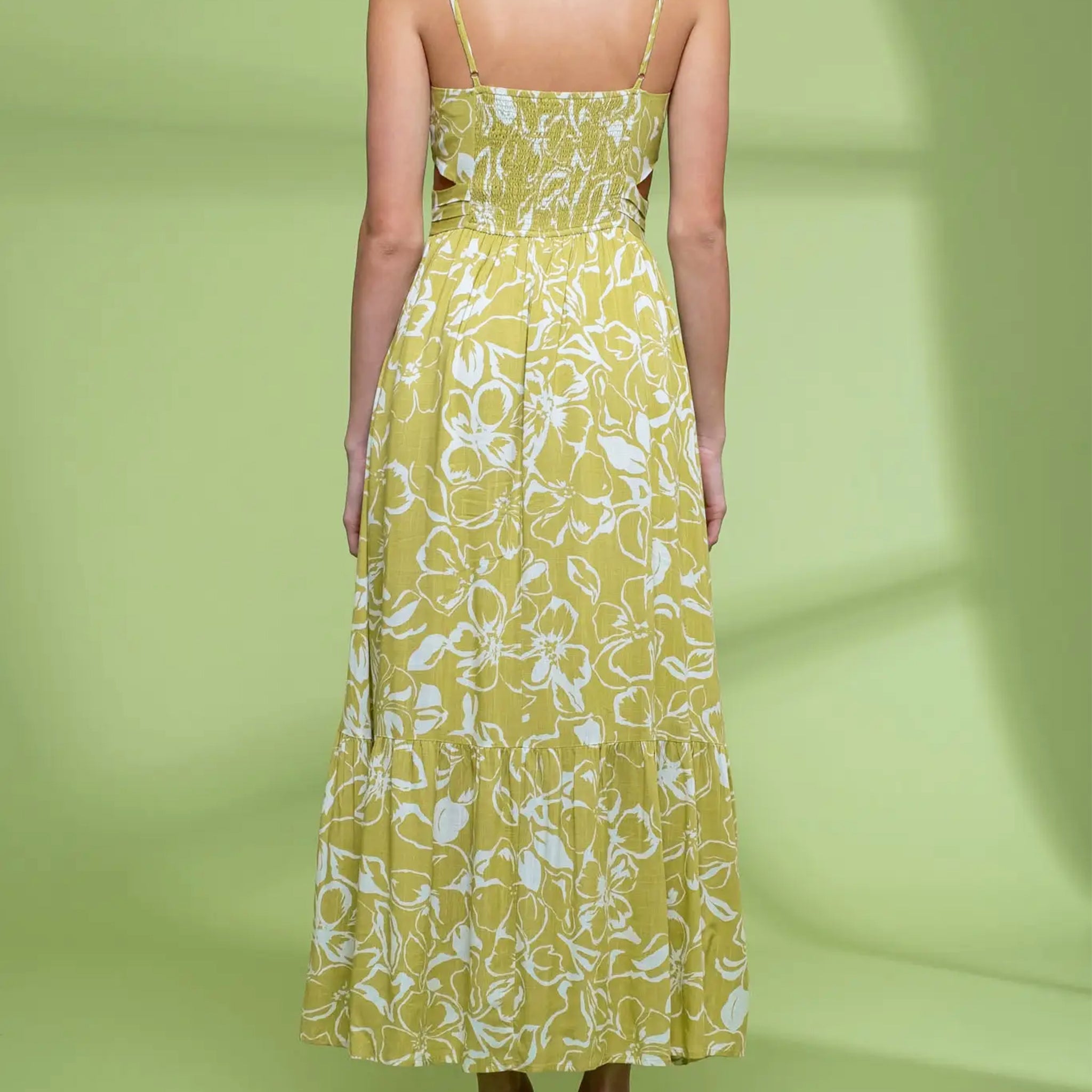 A lime green and white spaghetti strapped midi dress with a floral print.