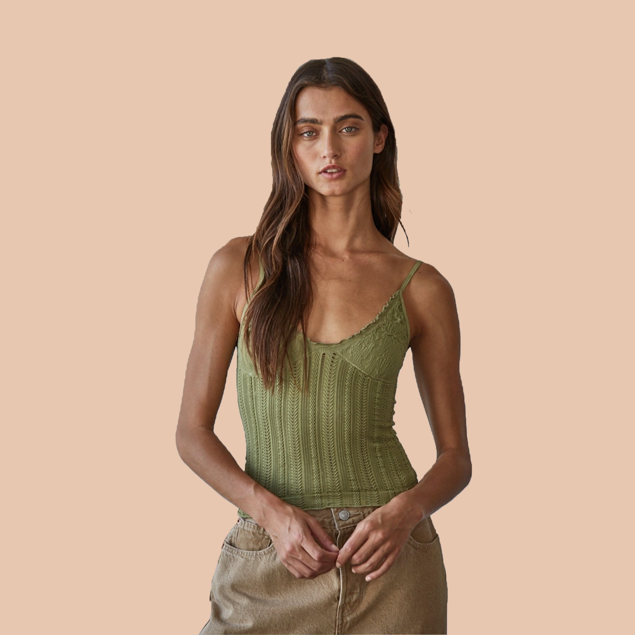 A green tank top with a v-neck, textured details and thin spaghetti straps. 