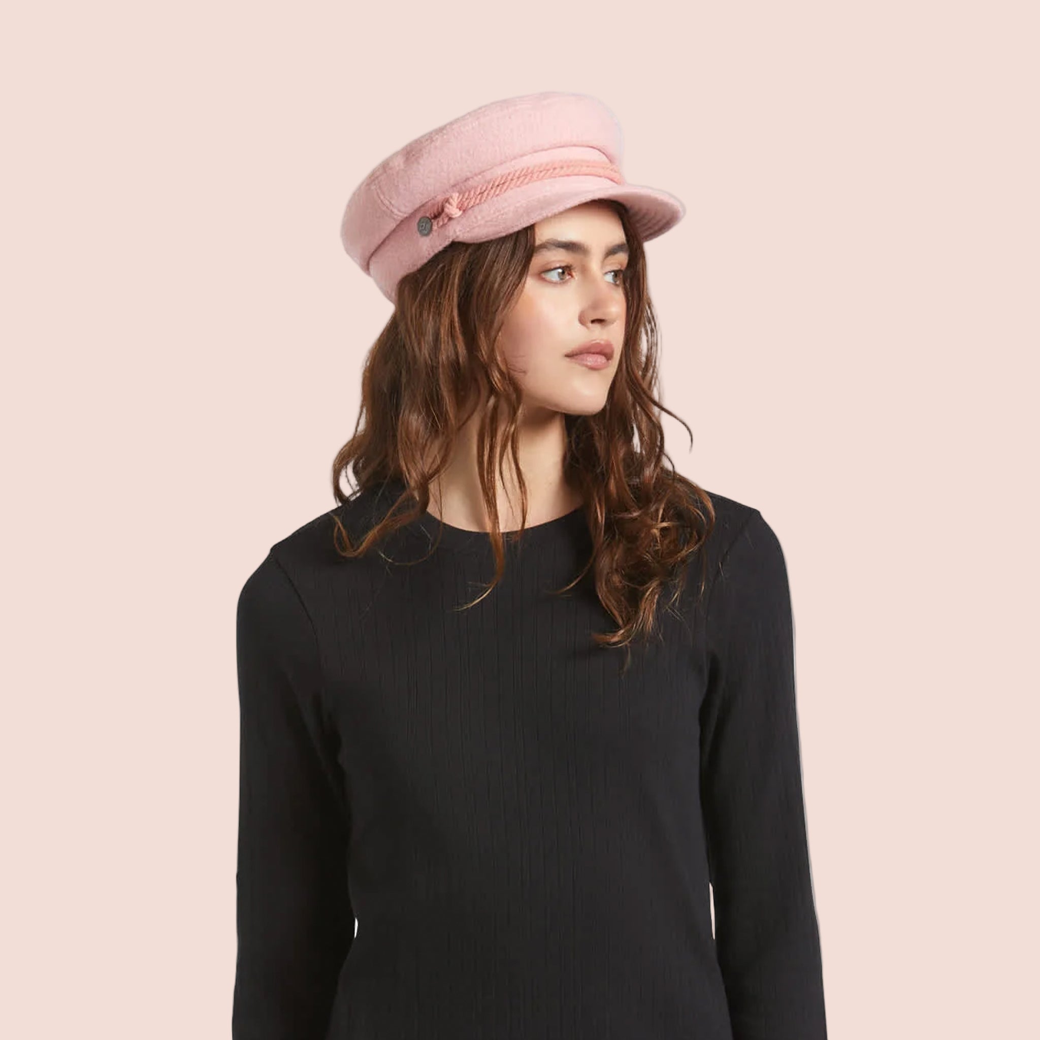 A soft pink boucle cap hat with rope detailing. 