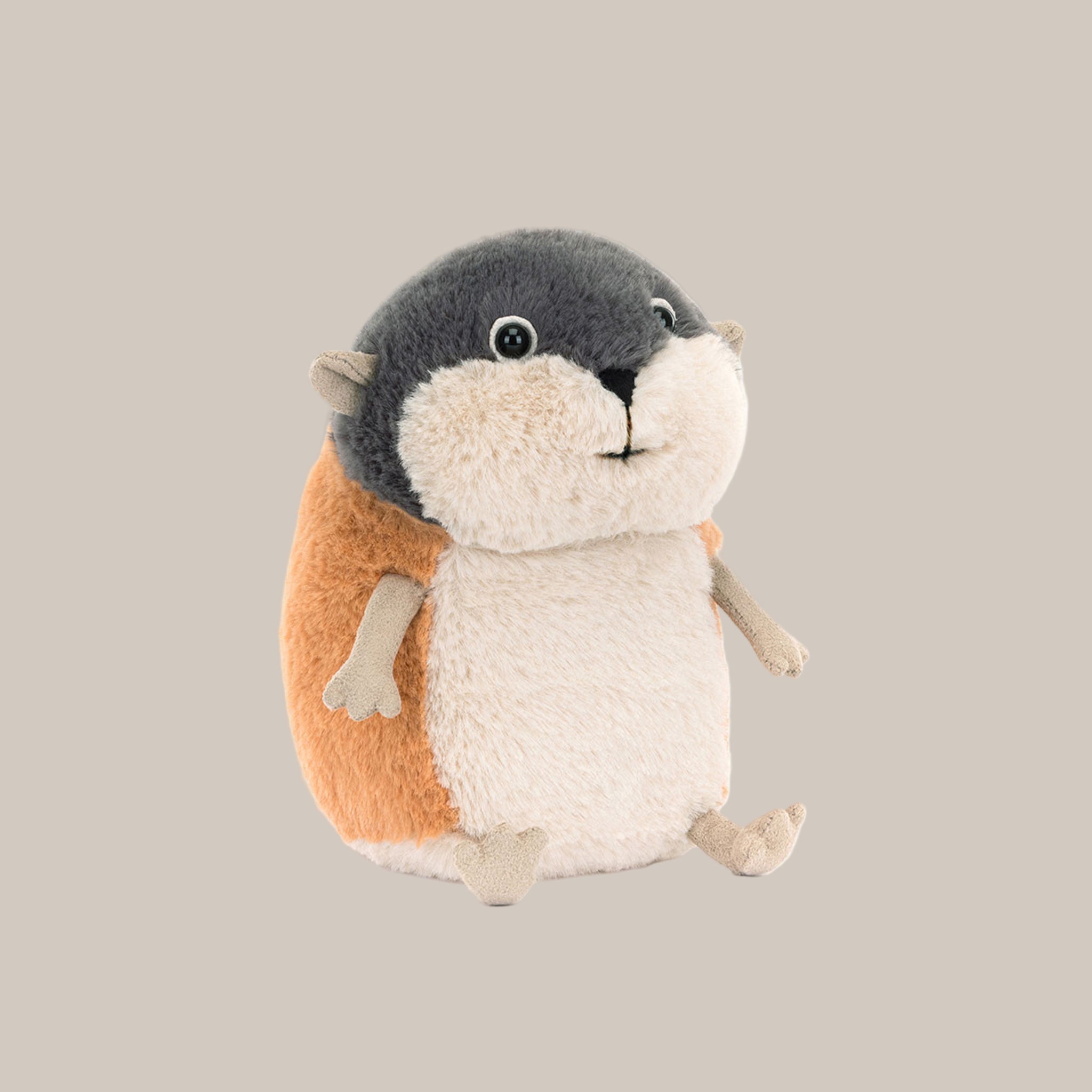 A grey, white and orange lemming shaped stuffed toy. 