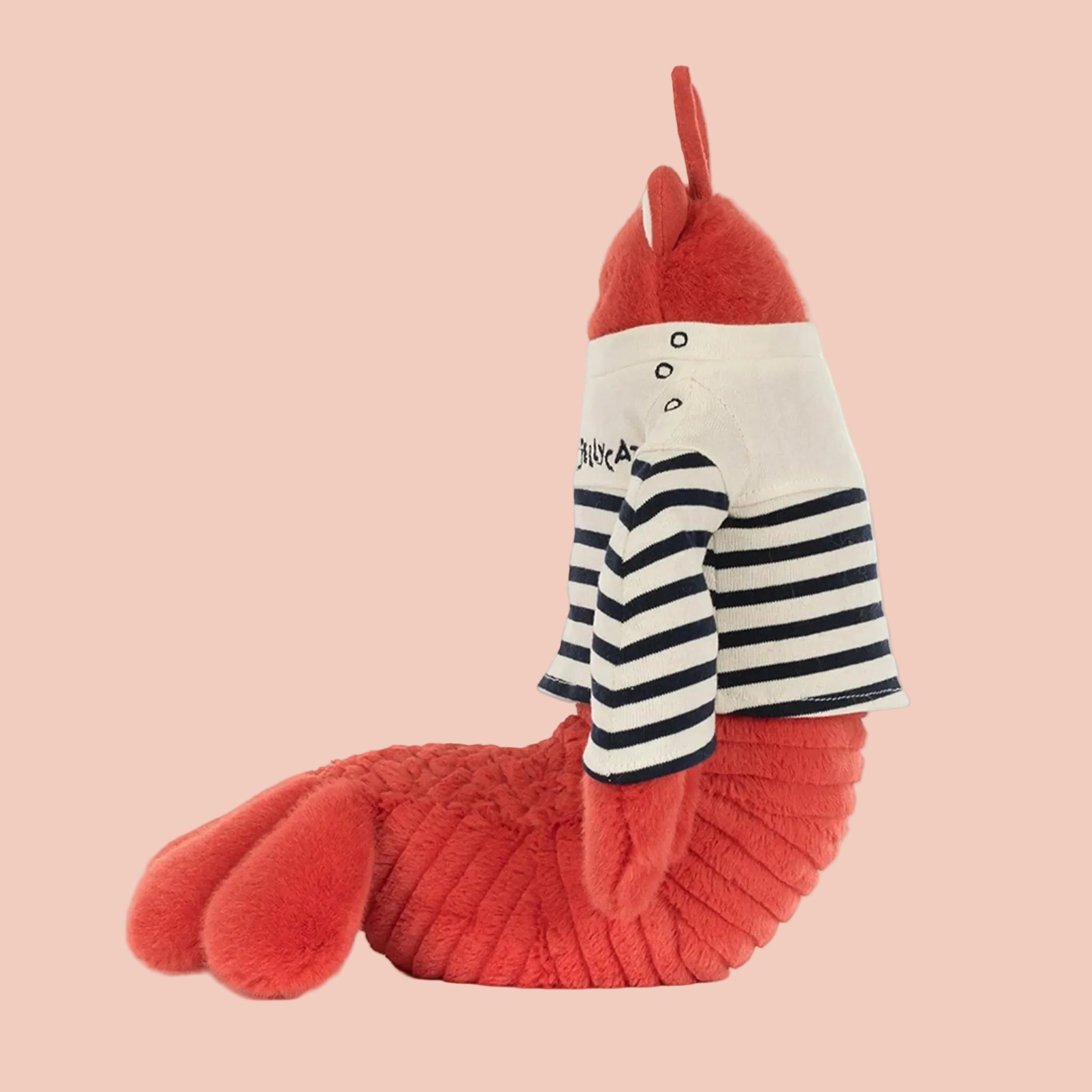 Red lobster plush toy with a striped shirt on a beige background