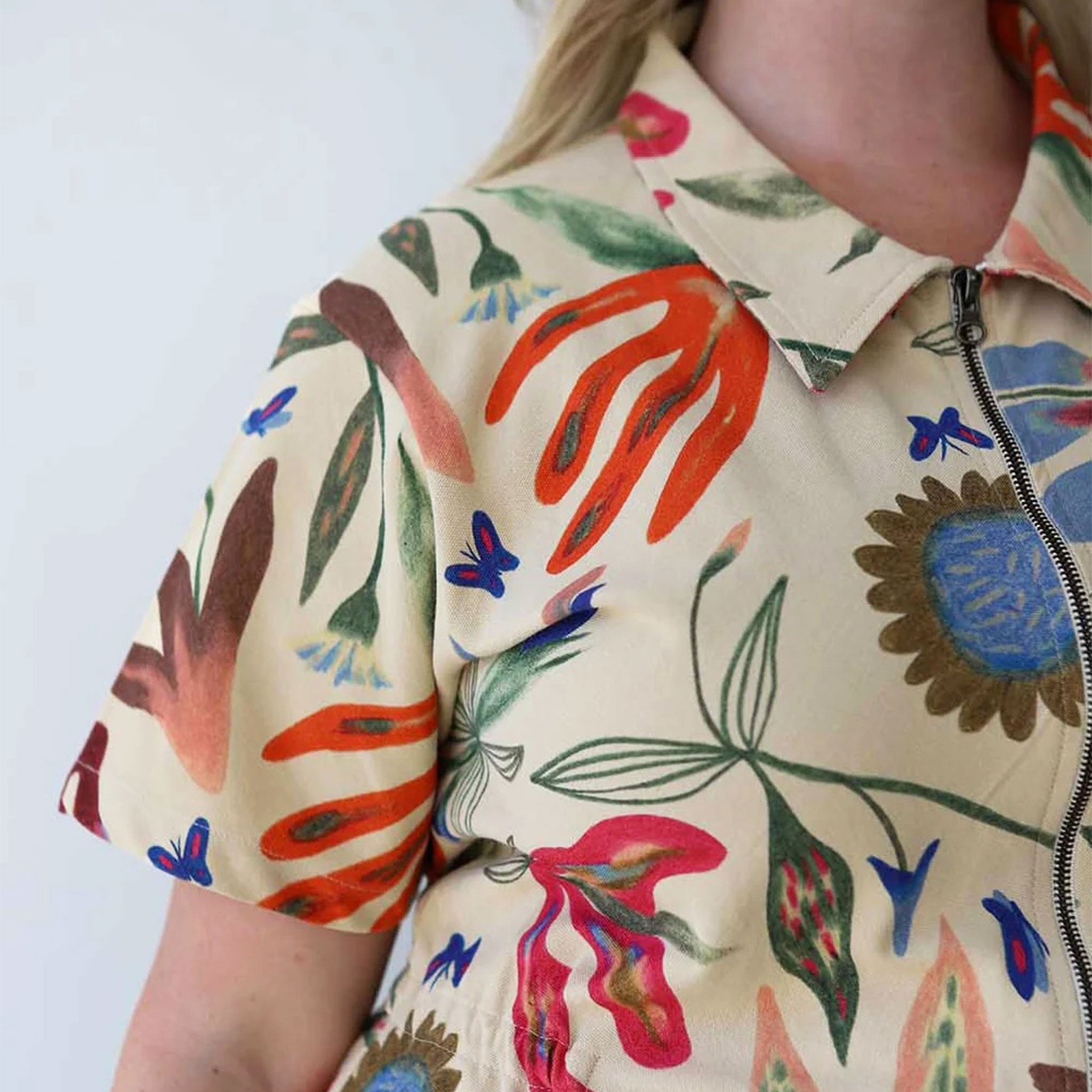 A jumpsuit with a multicolored patten and front zipper. 