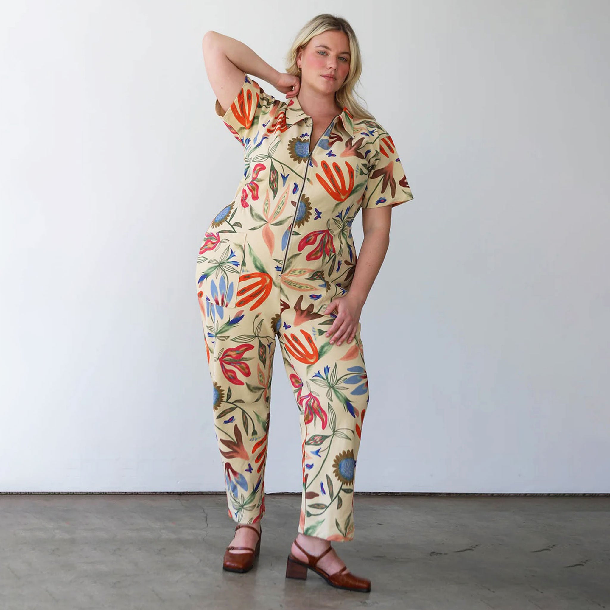 A jumpsuit with a multicolored patten and front zipper. 