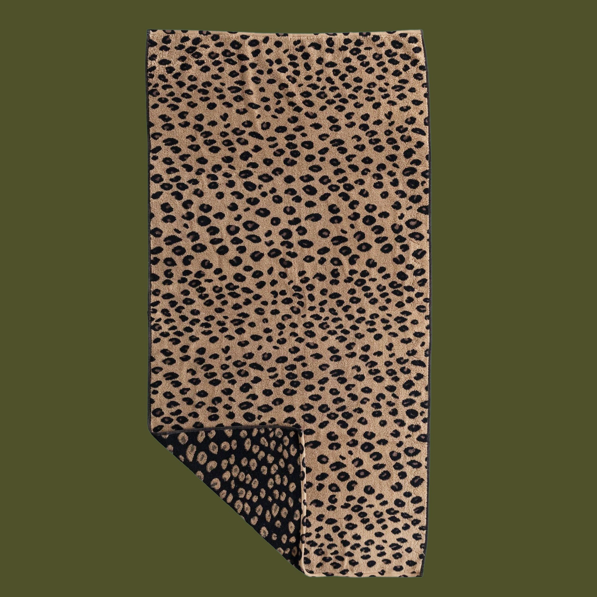 A black and brown leopard print bath towel. 