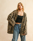 A tan and black leopard print cardigan. 