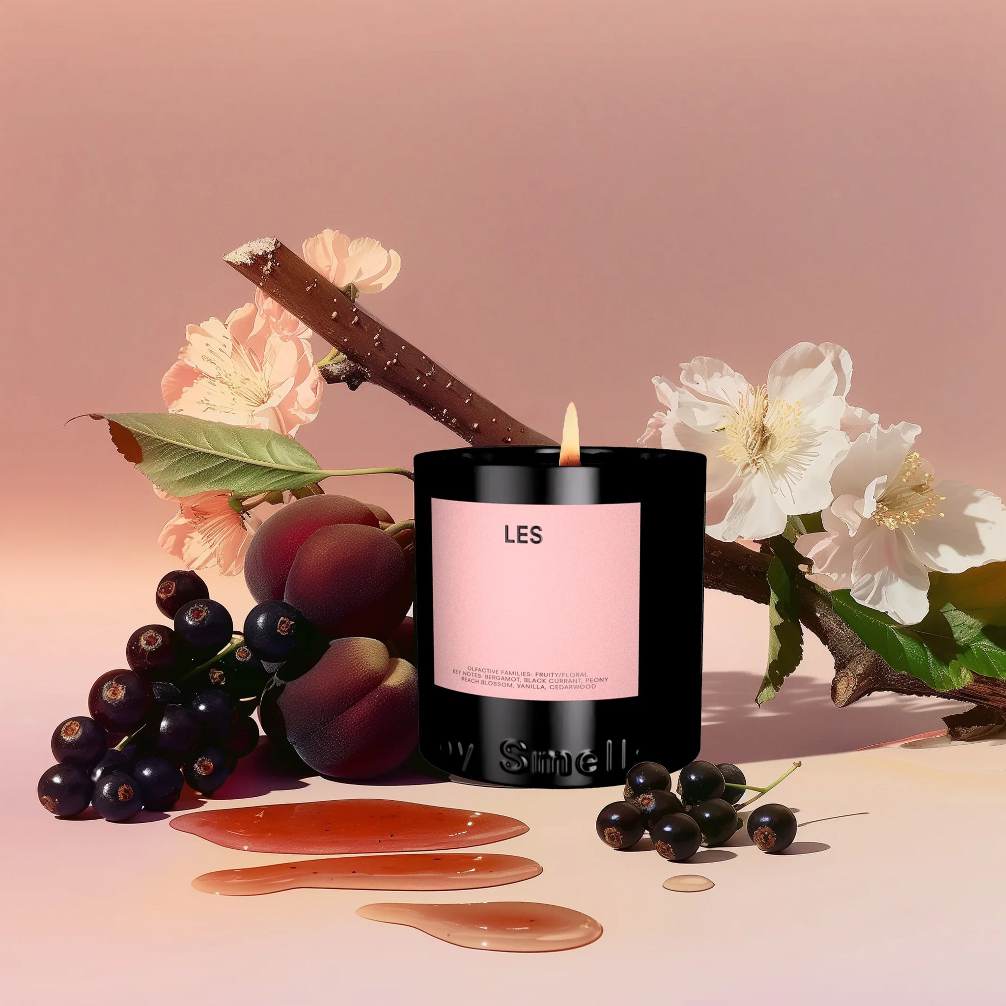 A black Boy Smells branded candle with a pink label that reads, "LES" in black text. 