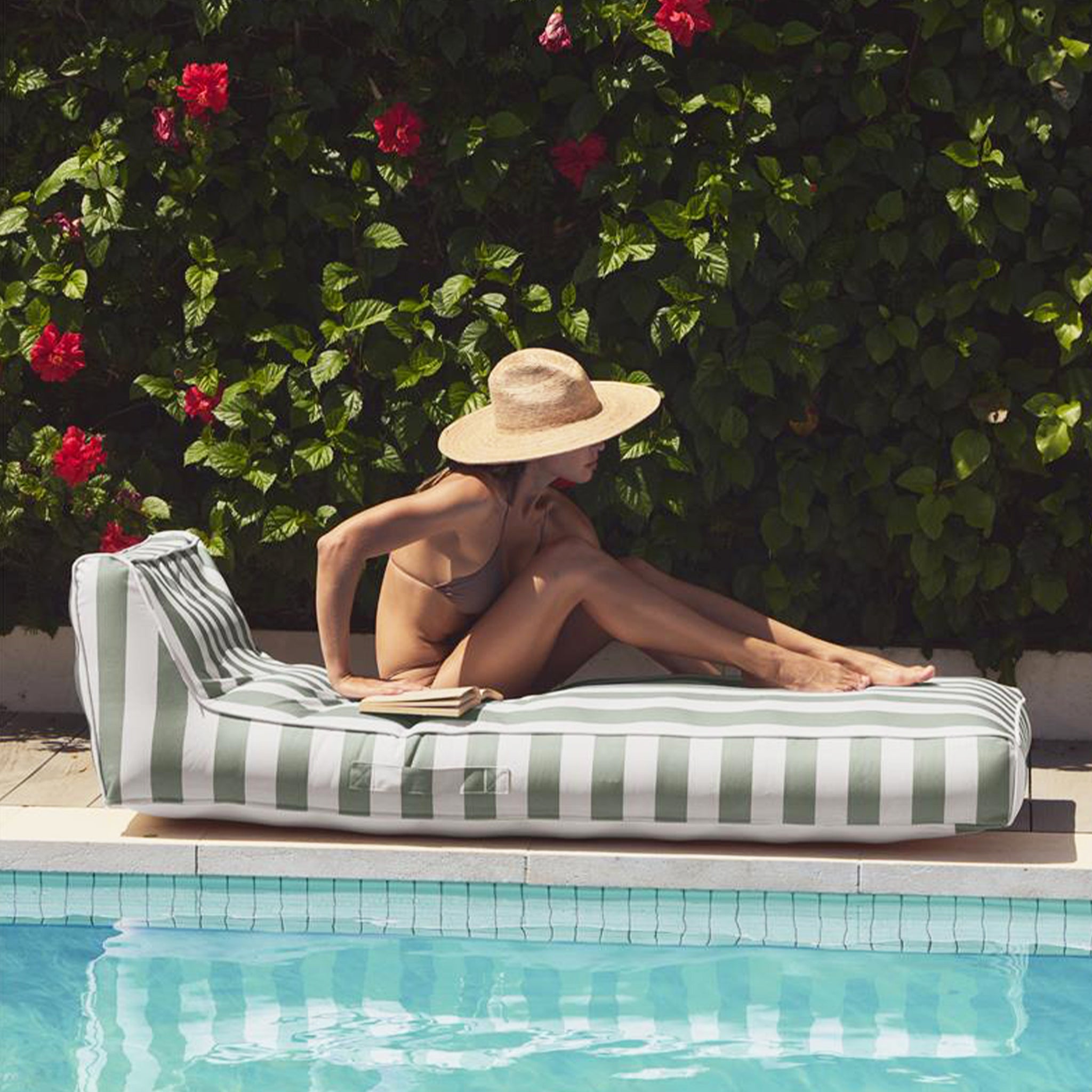 A white and green striped sun lounger float. 