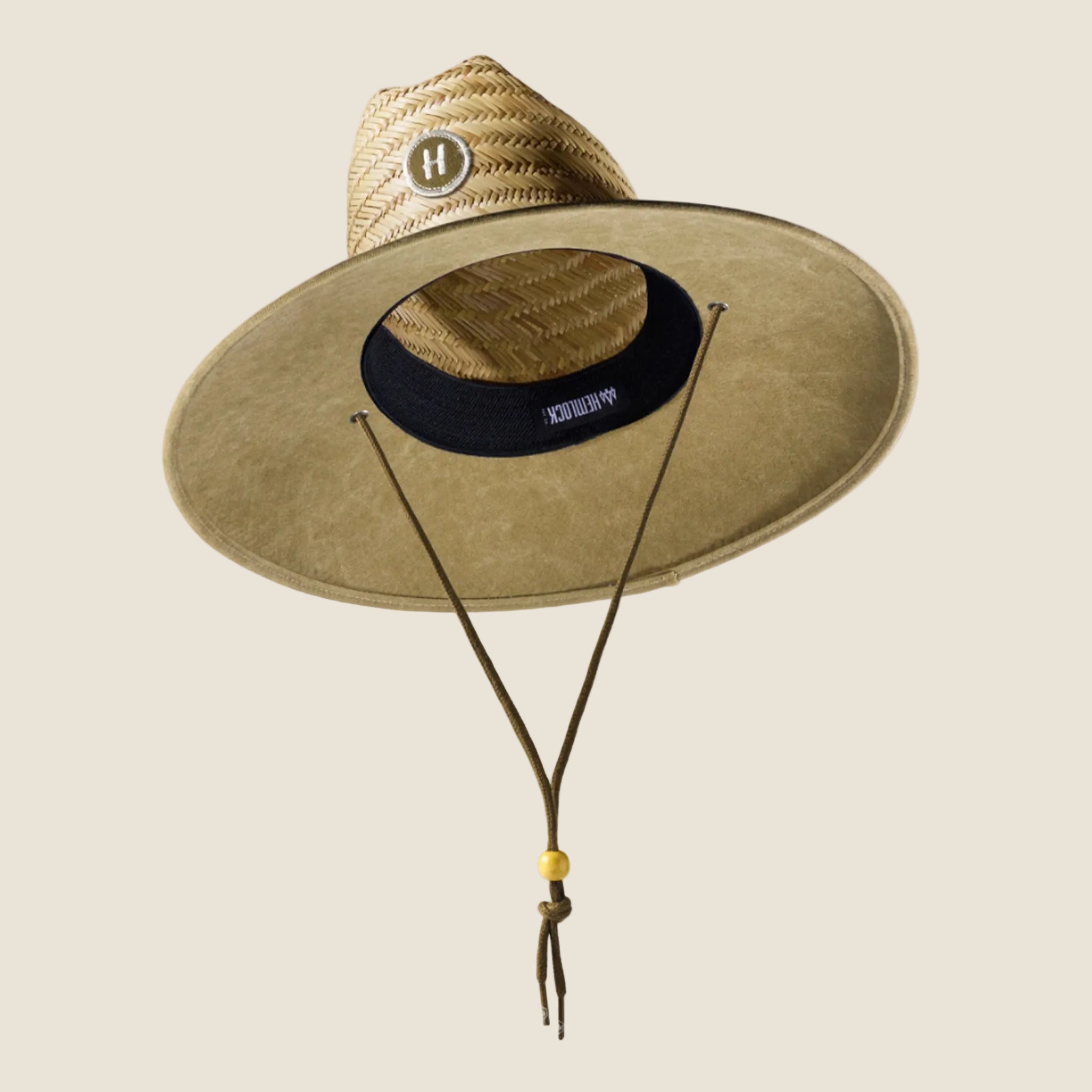 A straw hat with a solid olive green brim. 