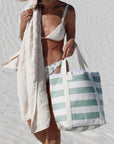 A light sage and striped cooler tote bag. 