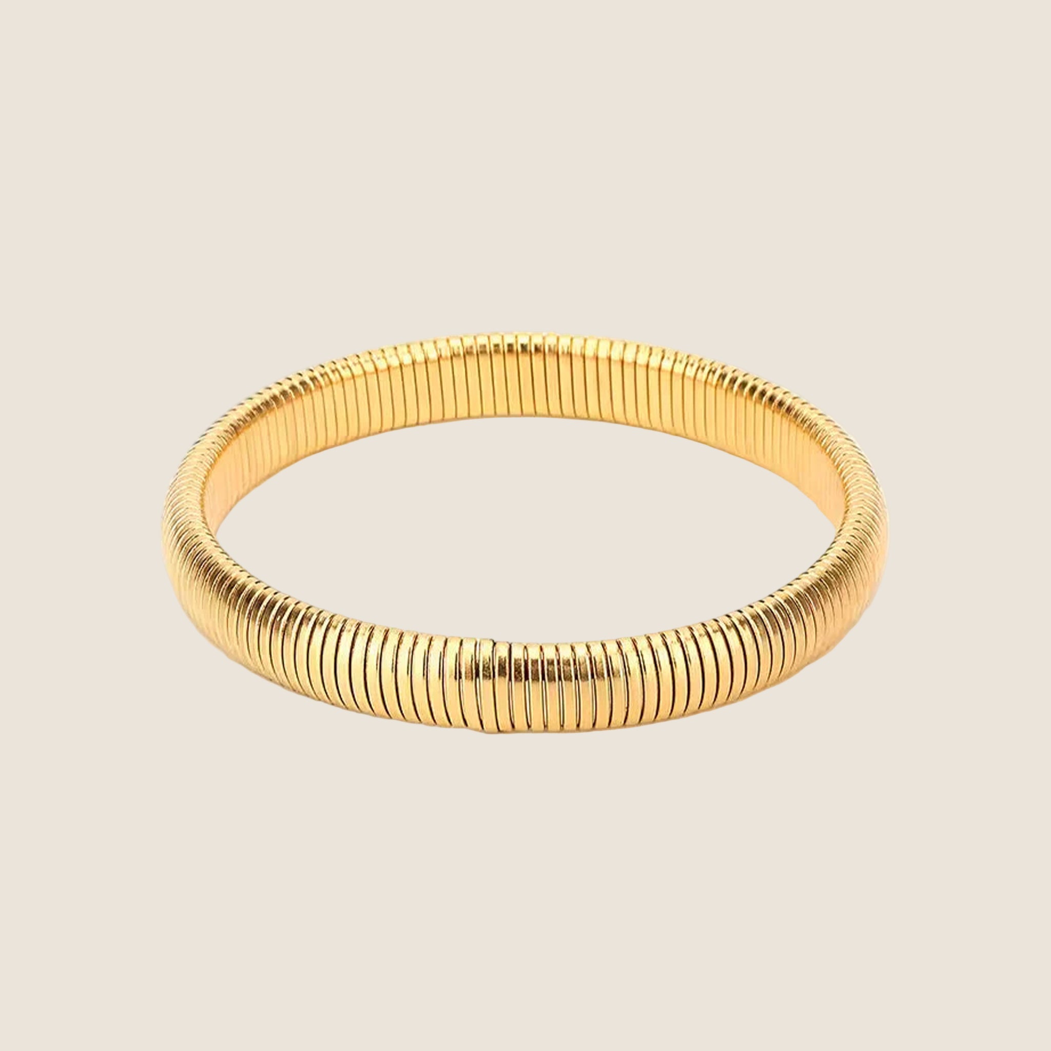 A gold chunky bangle bracelet. 