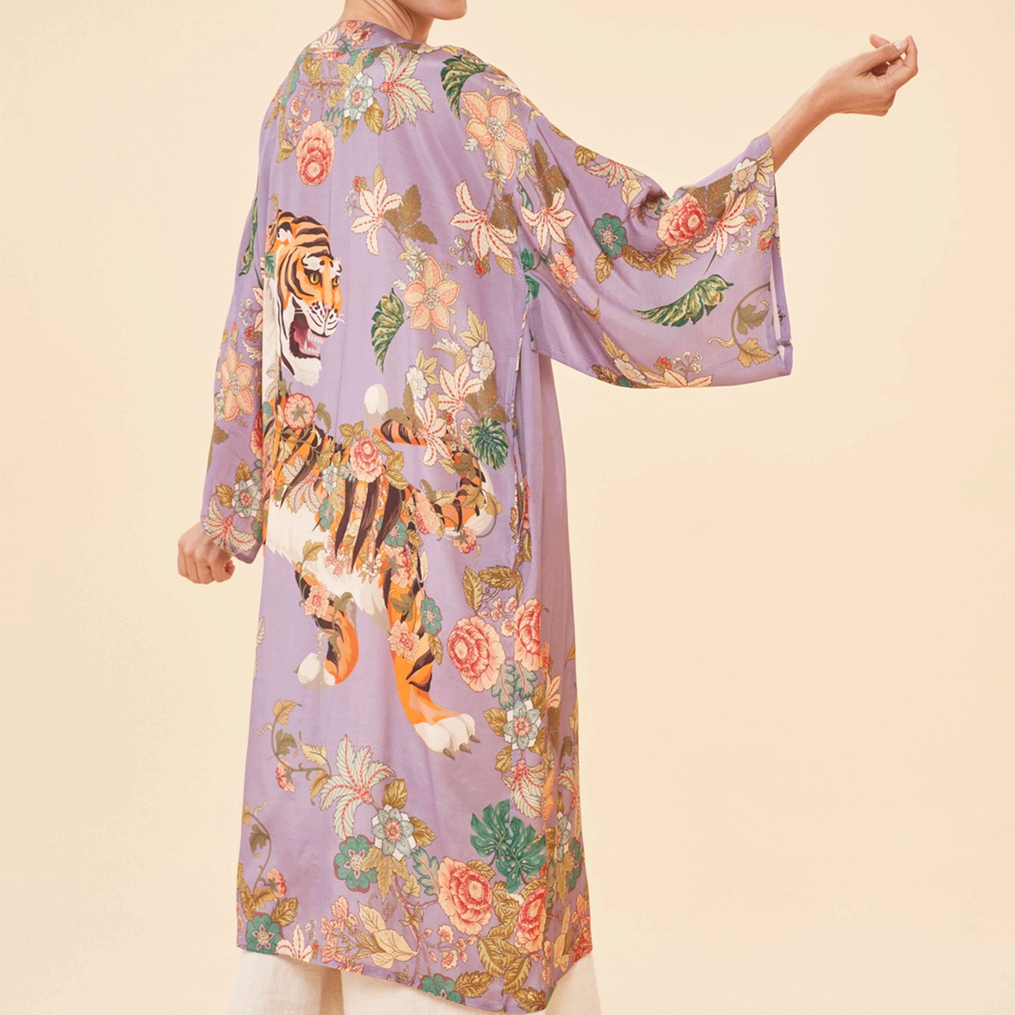 On a tan background is a lilac robe with a floral and tiger design.