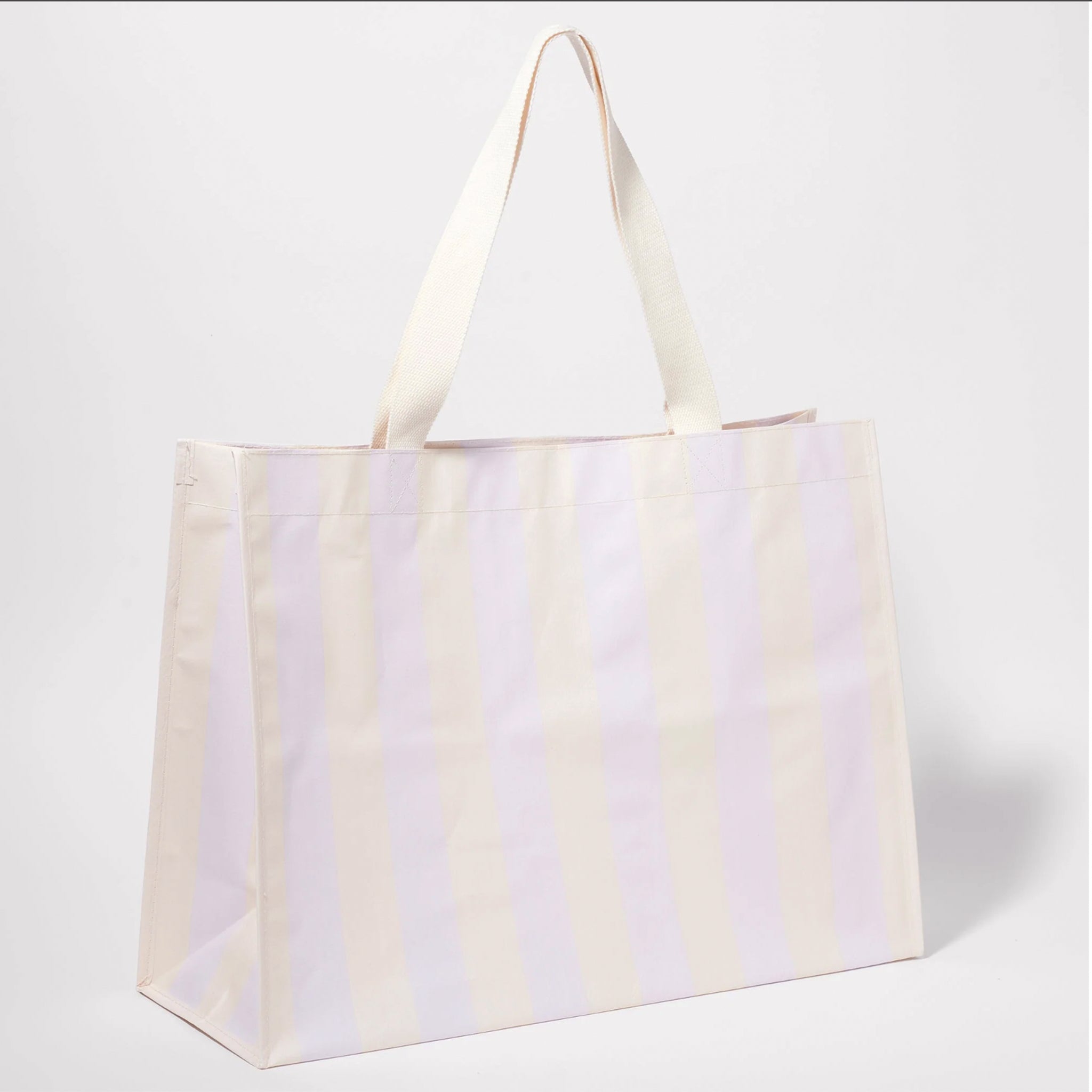 An oversized white and lilac striped beach tote with two shoulder straps.