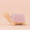 On a peachy background is lilac ceramic turtle shaped planter.