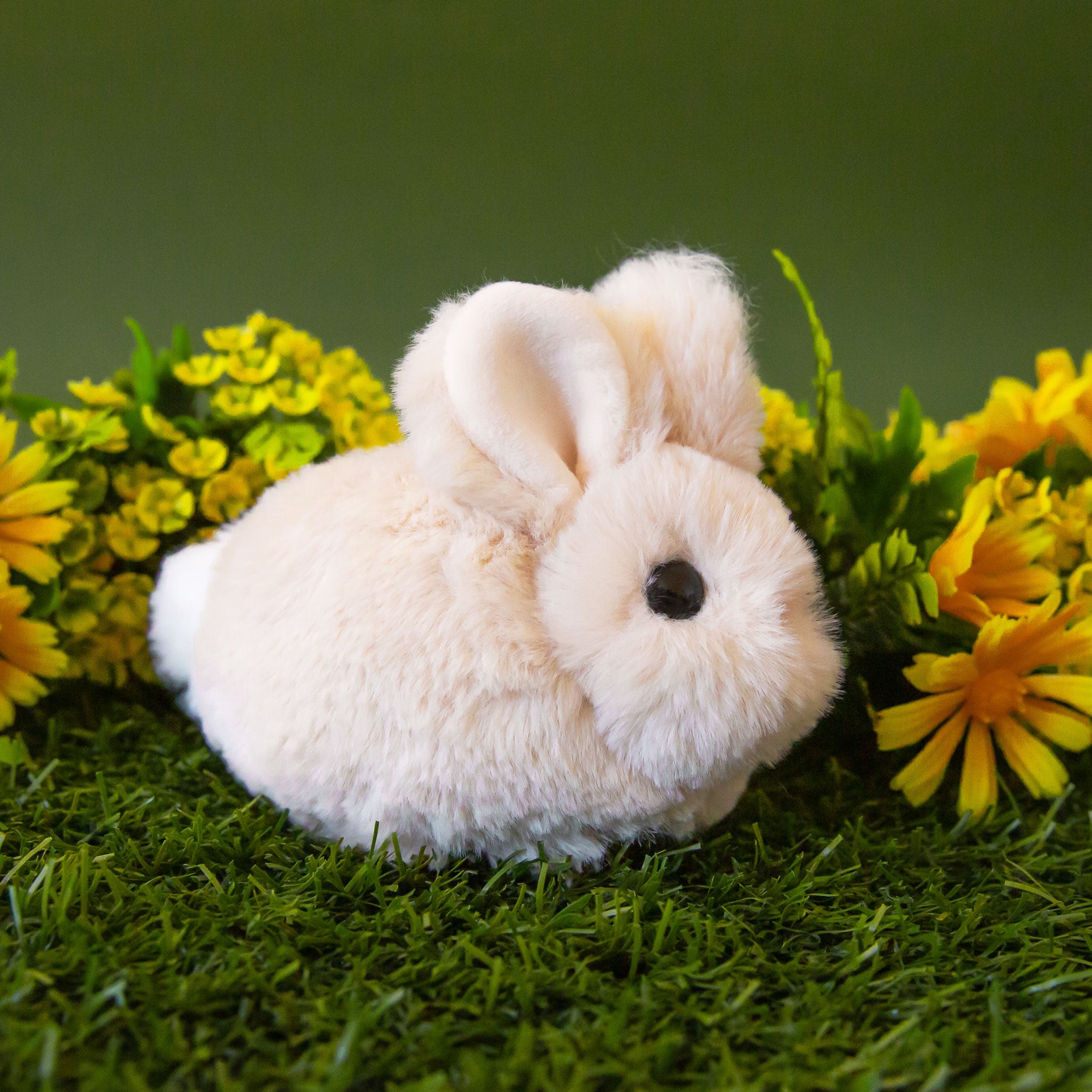 A tan tiny bunny shaped stuffed animal.