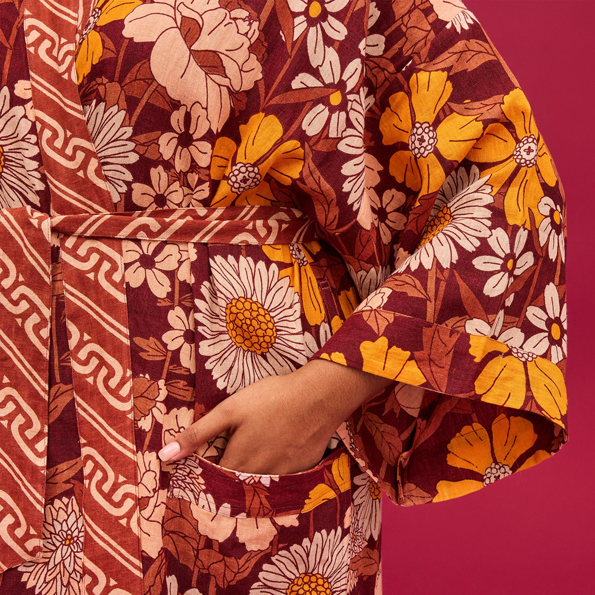 A rust, yellow and cream 70's inspired floral print linen robe.