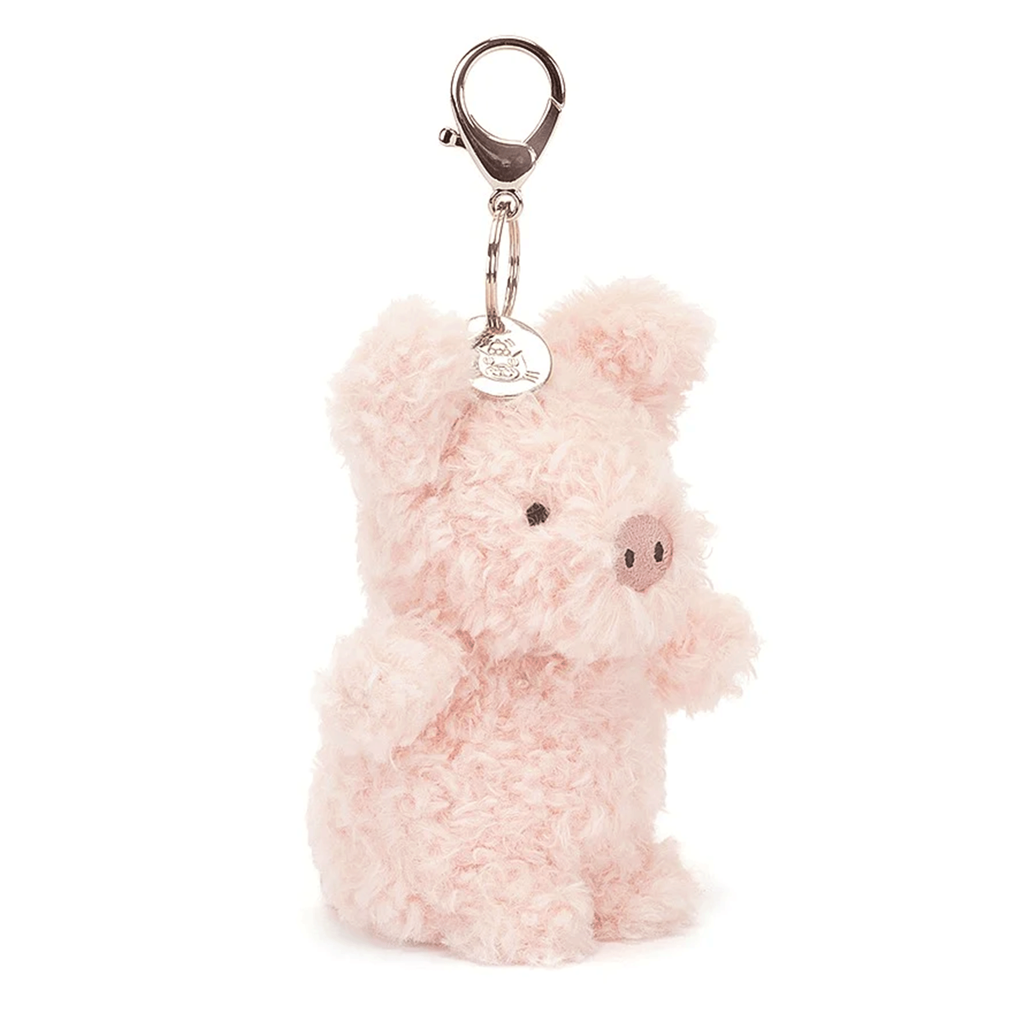 On a pink background is a pink pig bag charm with a silver clasp for attaching. 