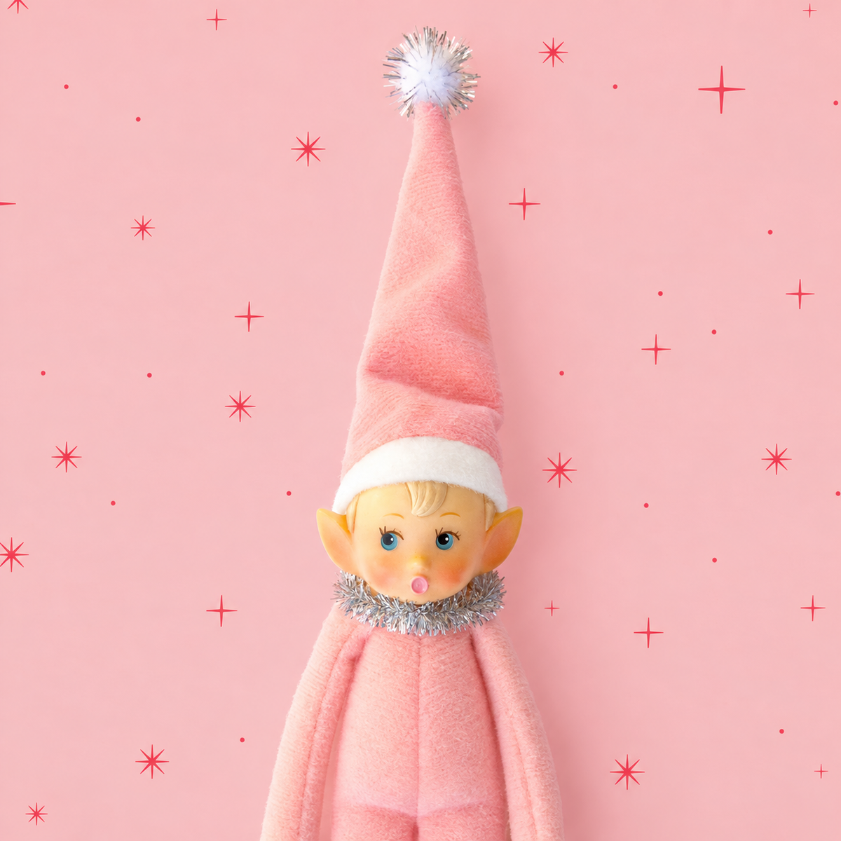 A light pink baby elf ornament. 