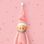 A light pink baby elf ornament. 