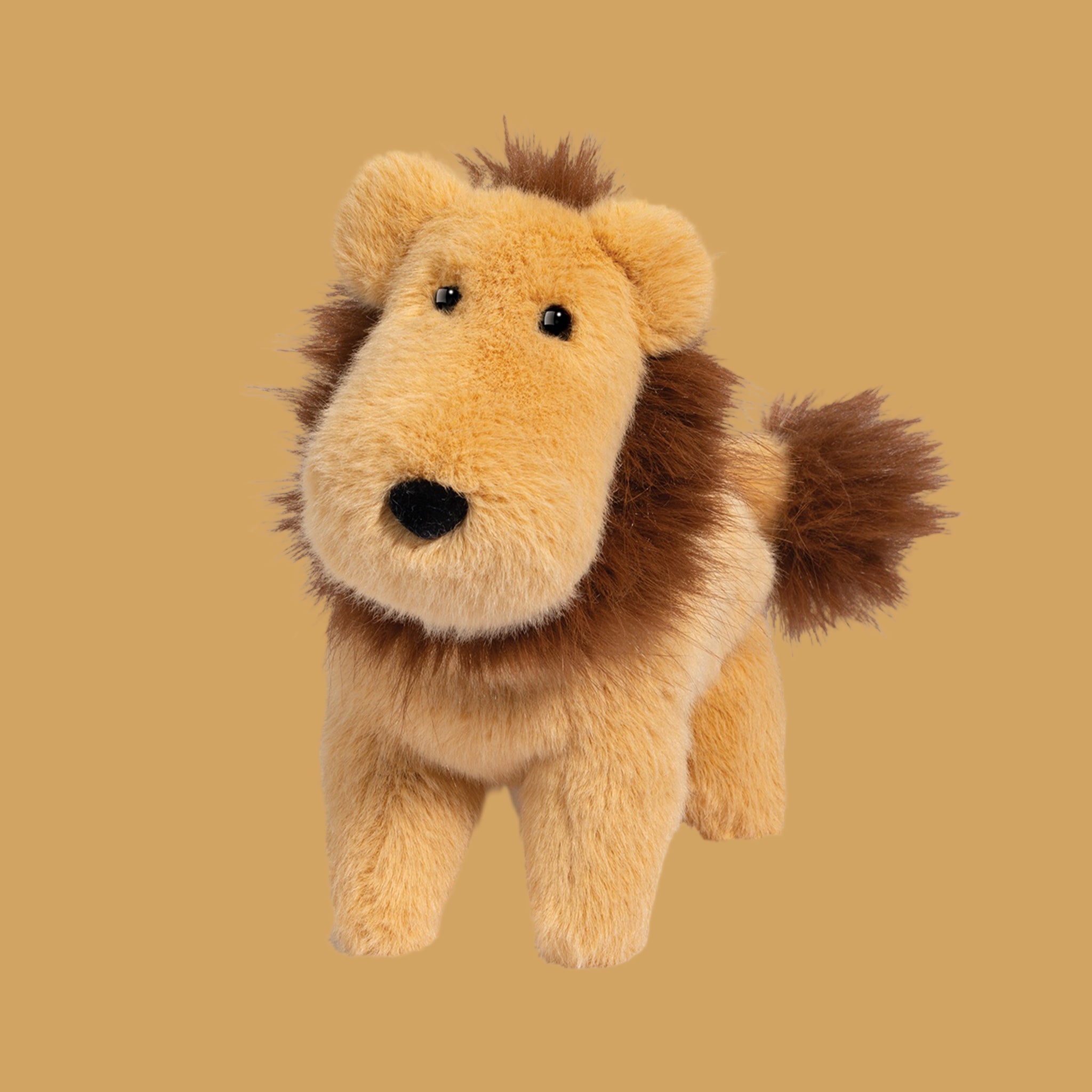 A lion shaped stuffed animal toy. 