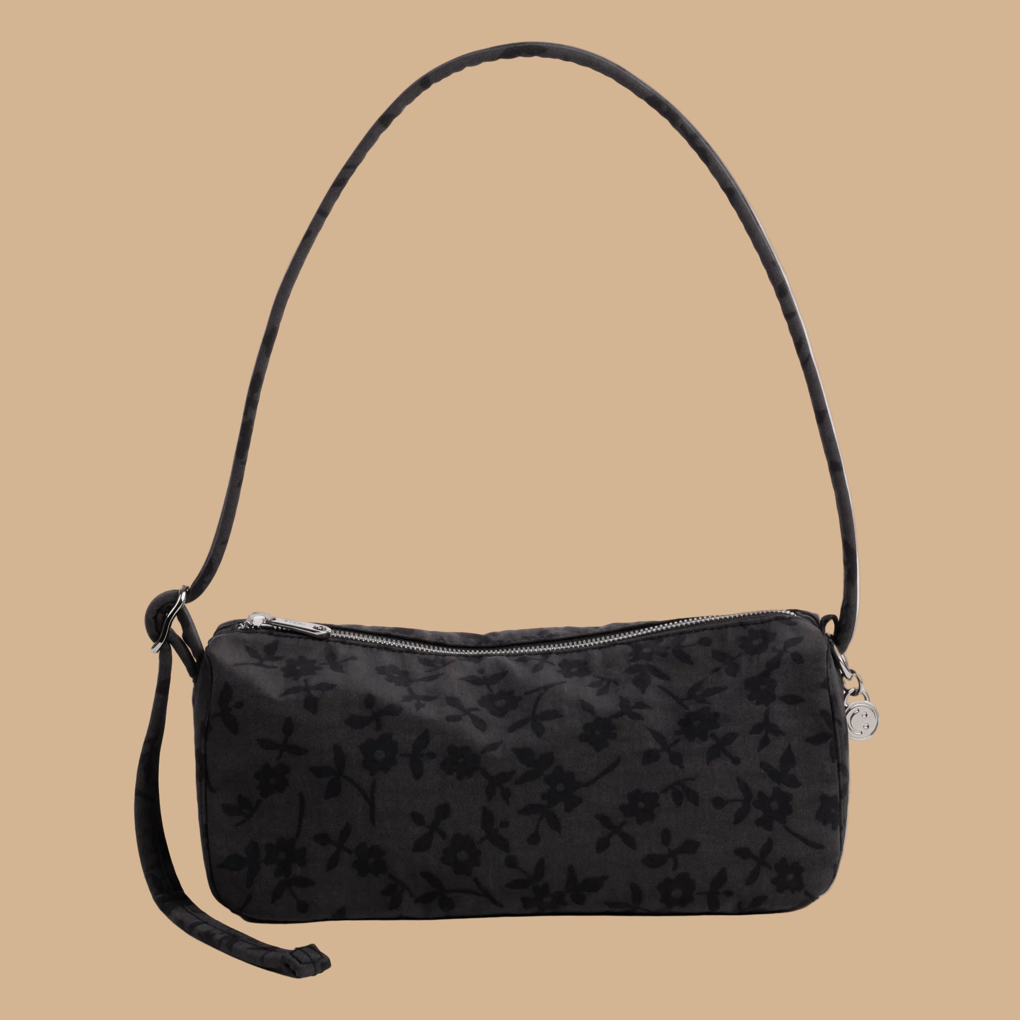 A charcoal shoulder bag with black floral print.